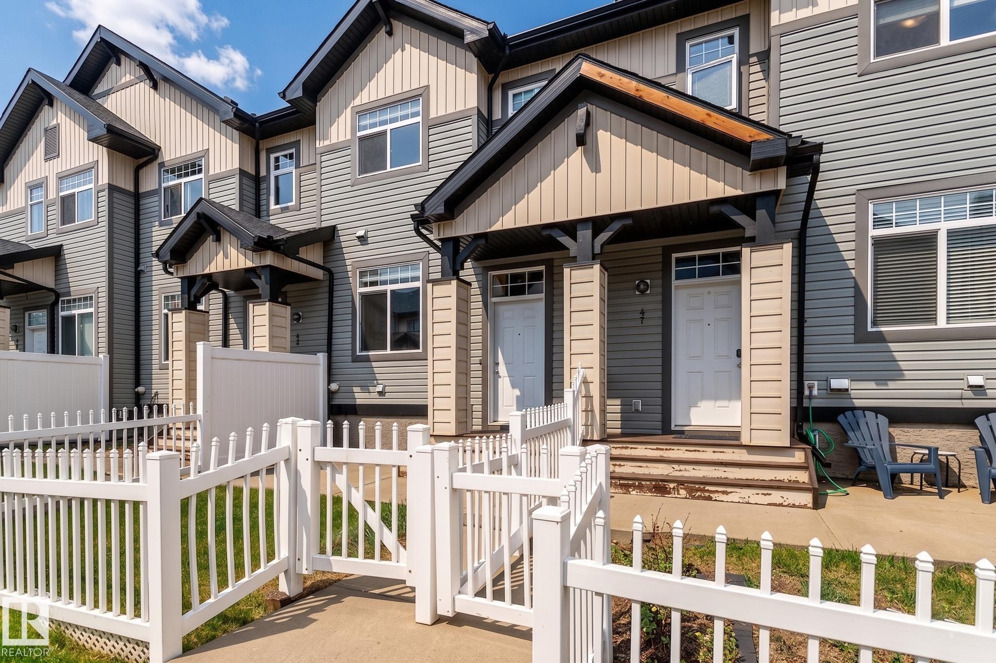 Multi-level townhome exterior featuring an inviting covered porch entry - 46 465 Hemingway Road, Edmonton, AB