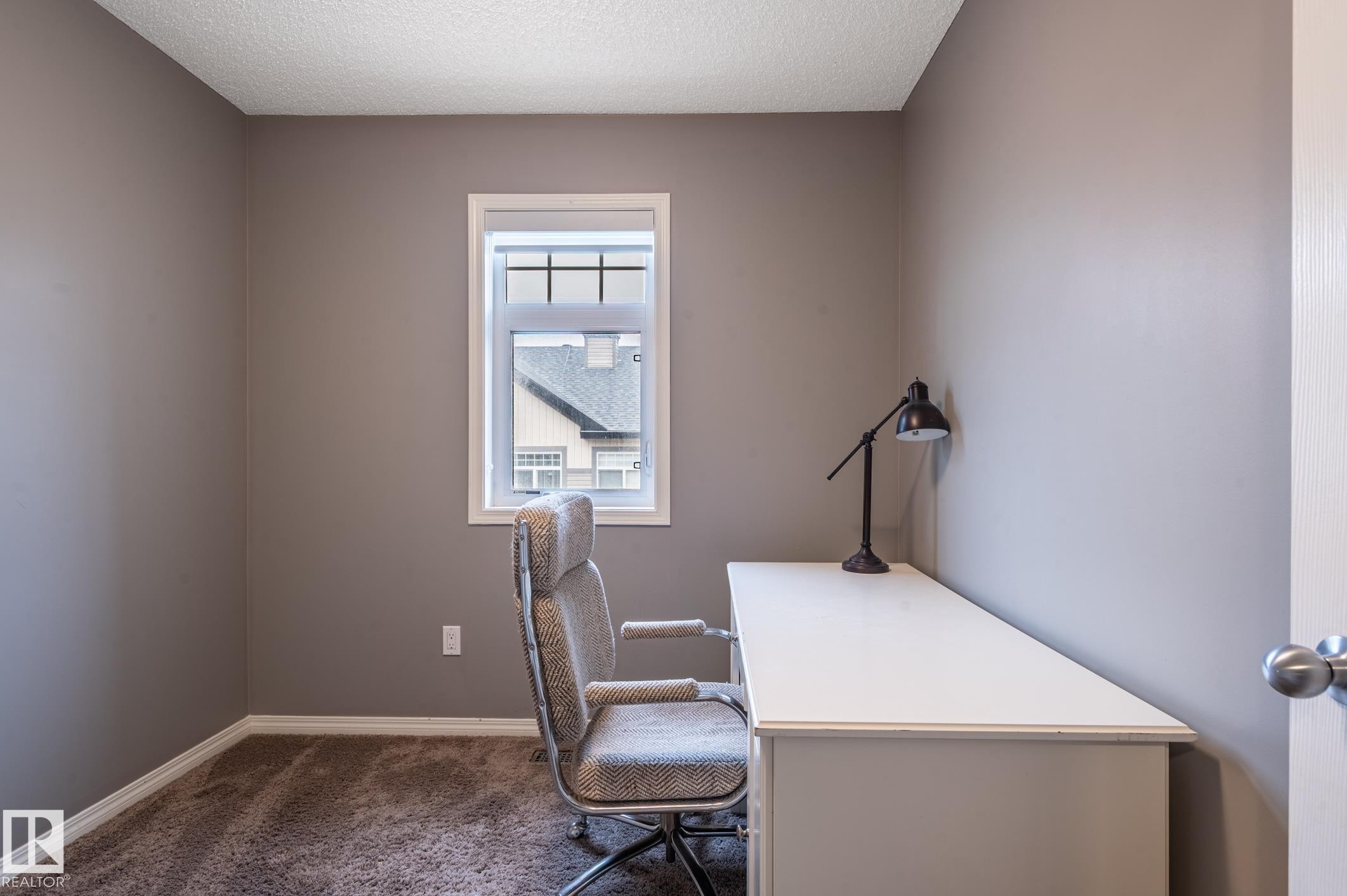 Compact room with a single window, neutral wall paint, and textured carpet flooring - 46 465 Hemingway Road, Edmonton, AB
