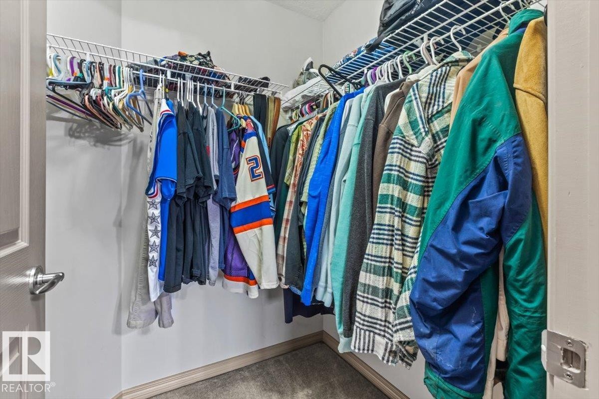 Walk-in closet featuring white wire shelving and hanging rods - 229 41 Summerwood Boulevard, Sherwood Park, AB - Indoor With Storage