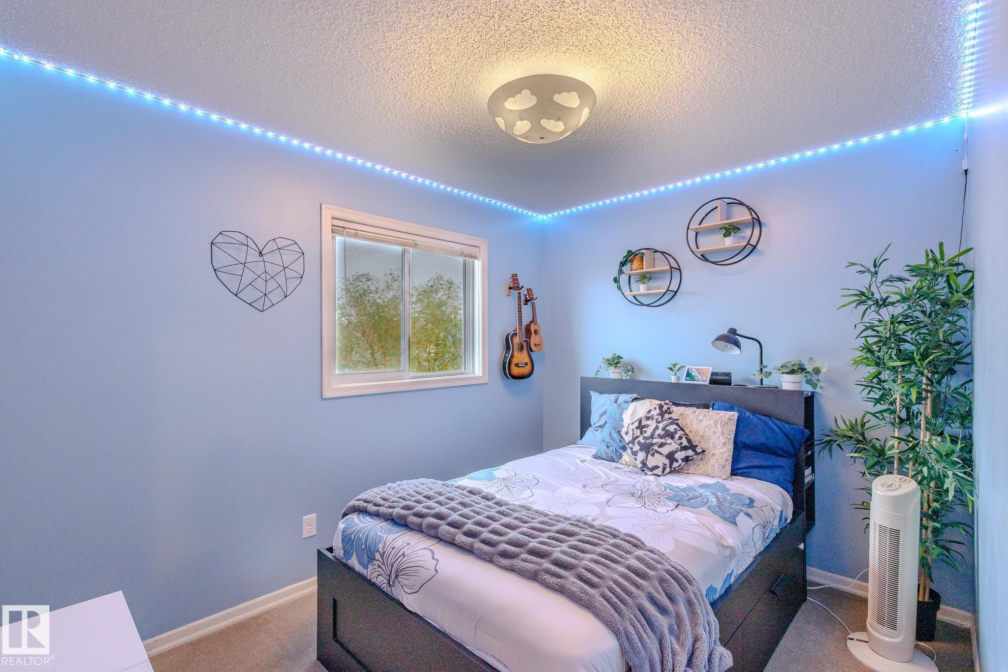 Room featuring light blue walls, a white-framed window, and a textured ceiling - 7207 14A Avenue, Edmonton, AB - Indoor Photo Showing Bedroom