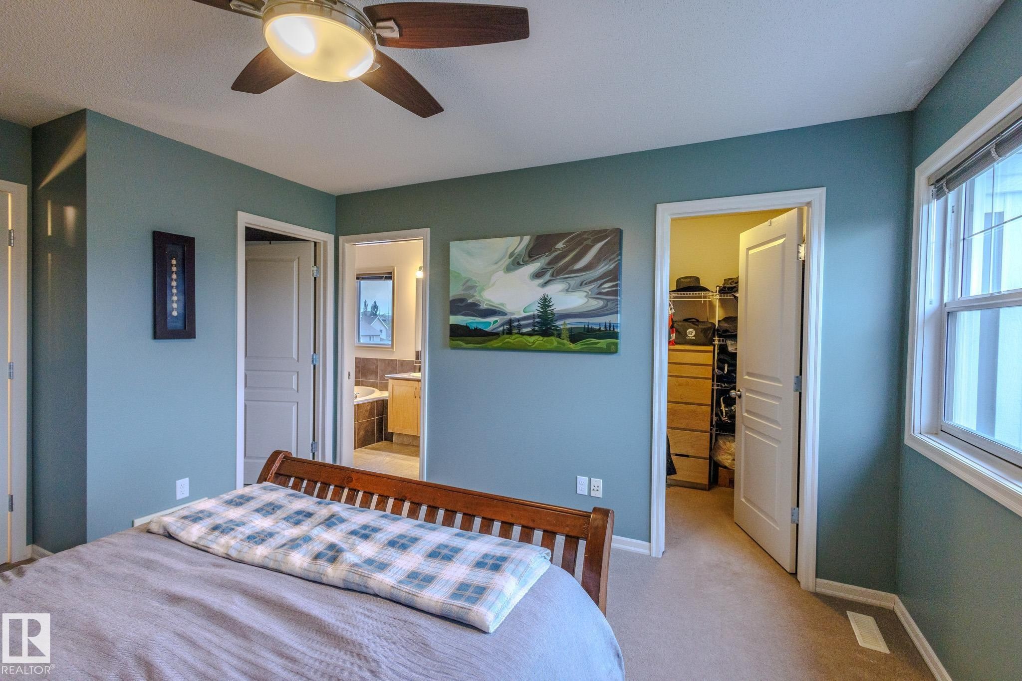 Bedroom featuring a ceiling fan with light fixture, light-colored carpeting, and a window with blinds - 7207 14A Avenue, Edmonton, AB - Indoor Photo Showing Bedroom