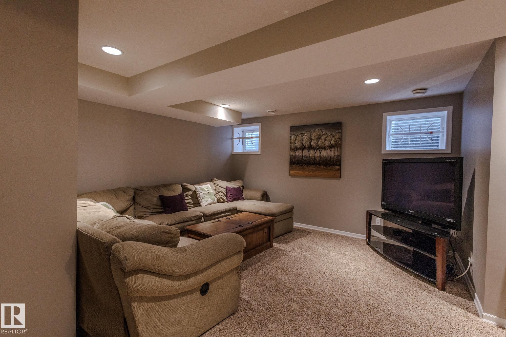 Finished basement space featuring recessed lighting, painted walls, carpeted flooring, and two visible windows - 7207 14A Avenue, Edmonton, AB - Indoor Photo Showing Basement