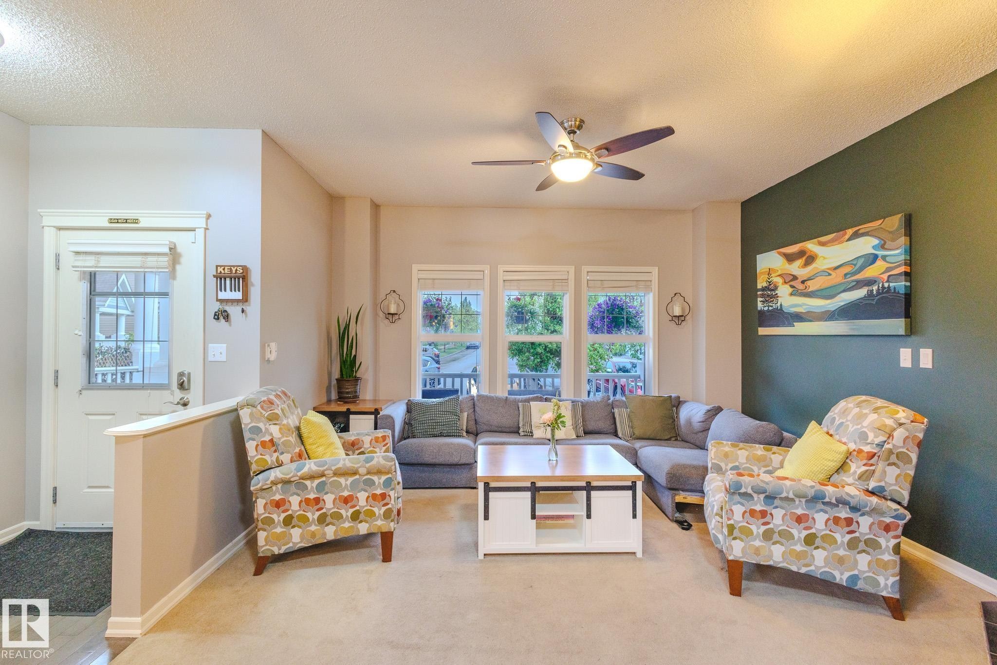 Living area with carpeting and a ceiling fan - 7207 14A Avenue, Edmonton, AB - Indoor Photo Showing Living Room