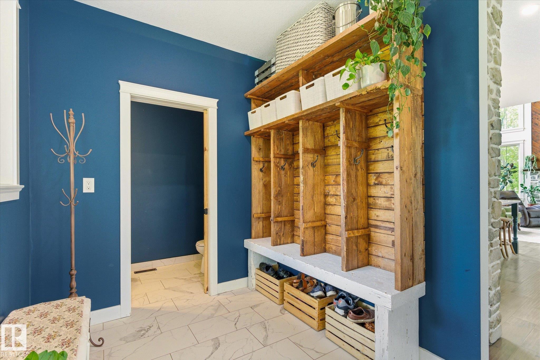 Built-in rustic wood shelving unit with bench seating and individual storage cubbies - 59102 Rge Road 234, Rural Westlock County, AB