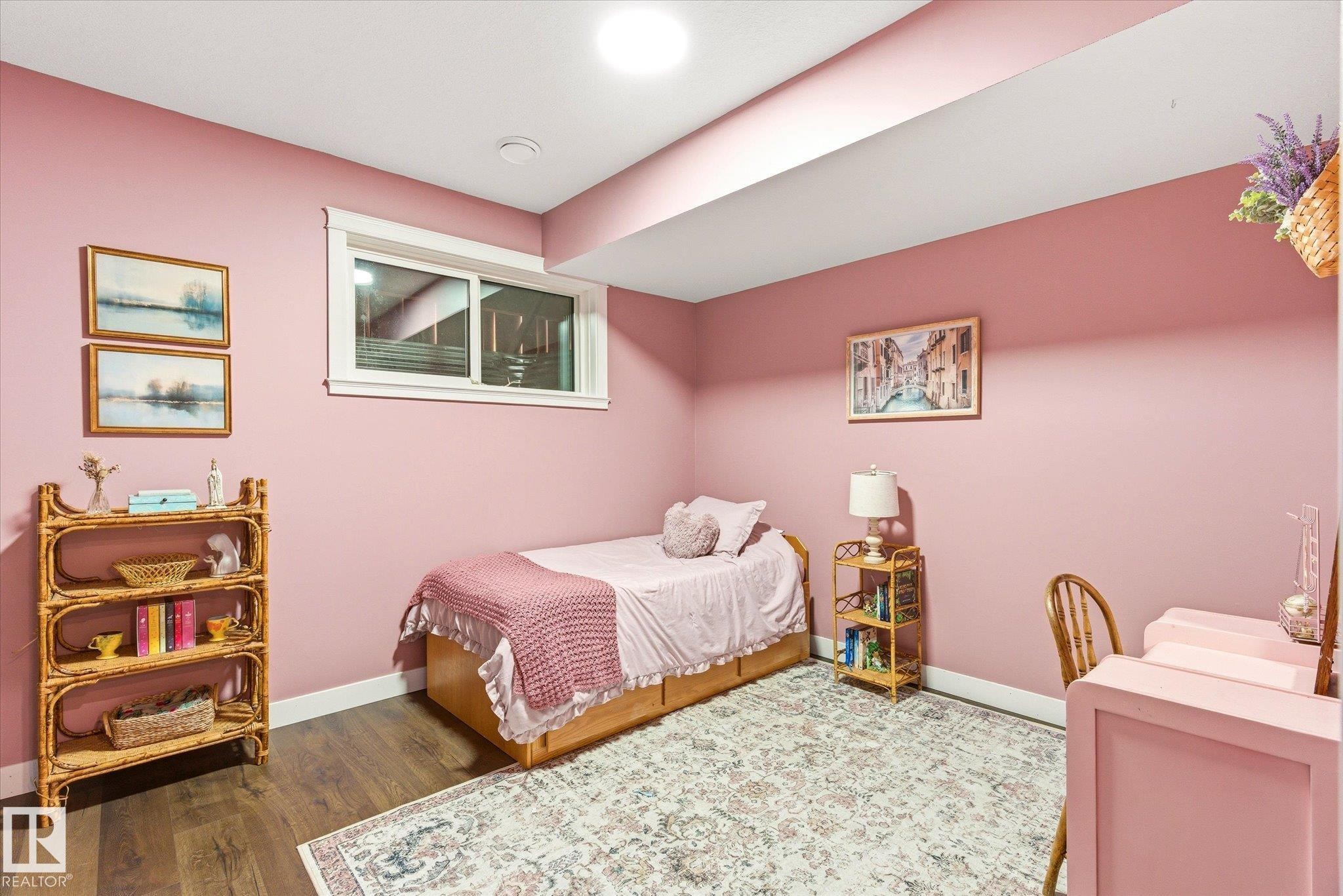 Spacious room featuring wood-finish flooring, a contemporary window with white trim, and recessed lighting - 59102 Rge Road 234, Rural Westlock County, AB