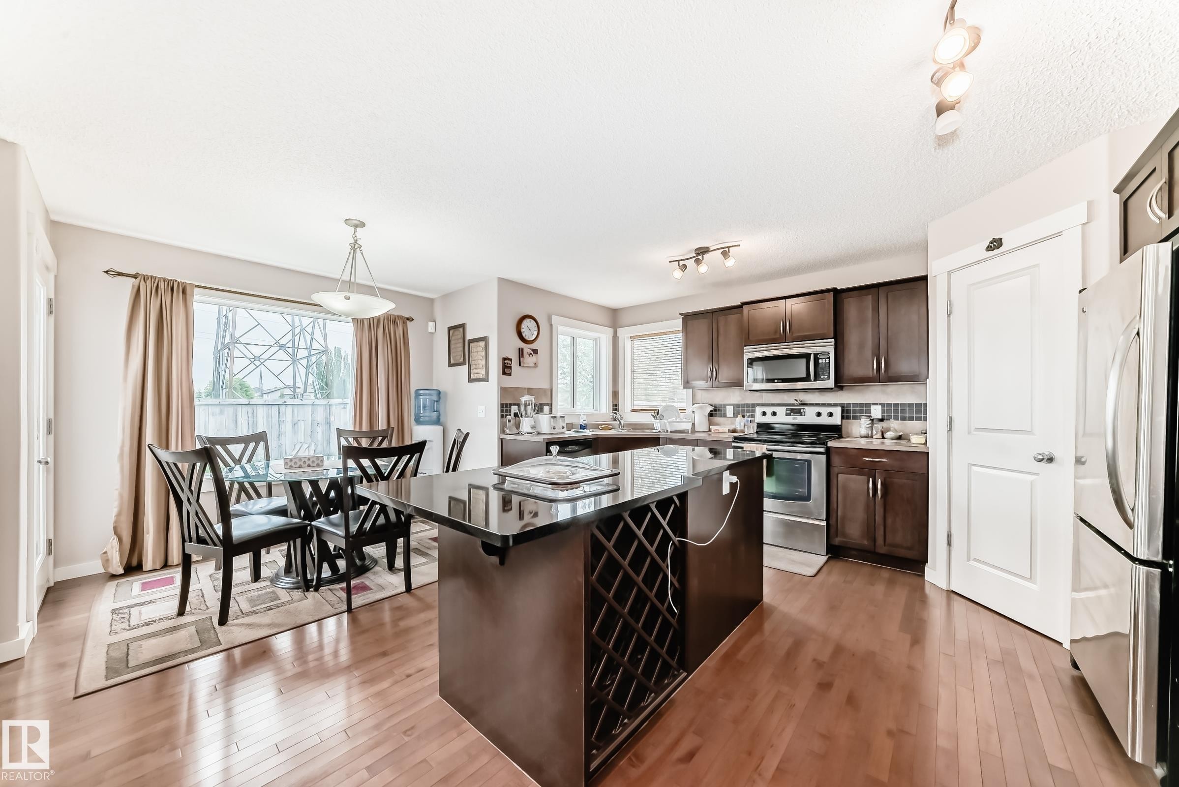 Open-concept kitchen and dining area with wood-finish flooring - 2808 36 Avenue, Edmonton, AB