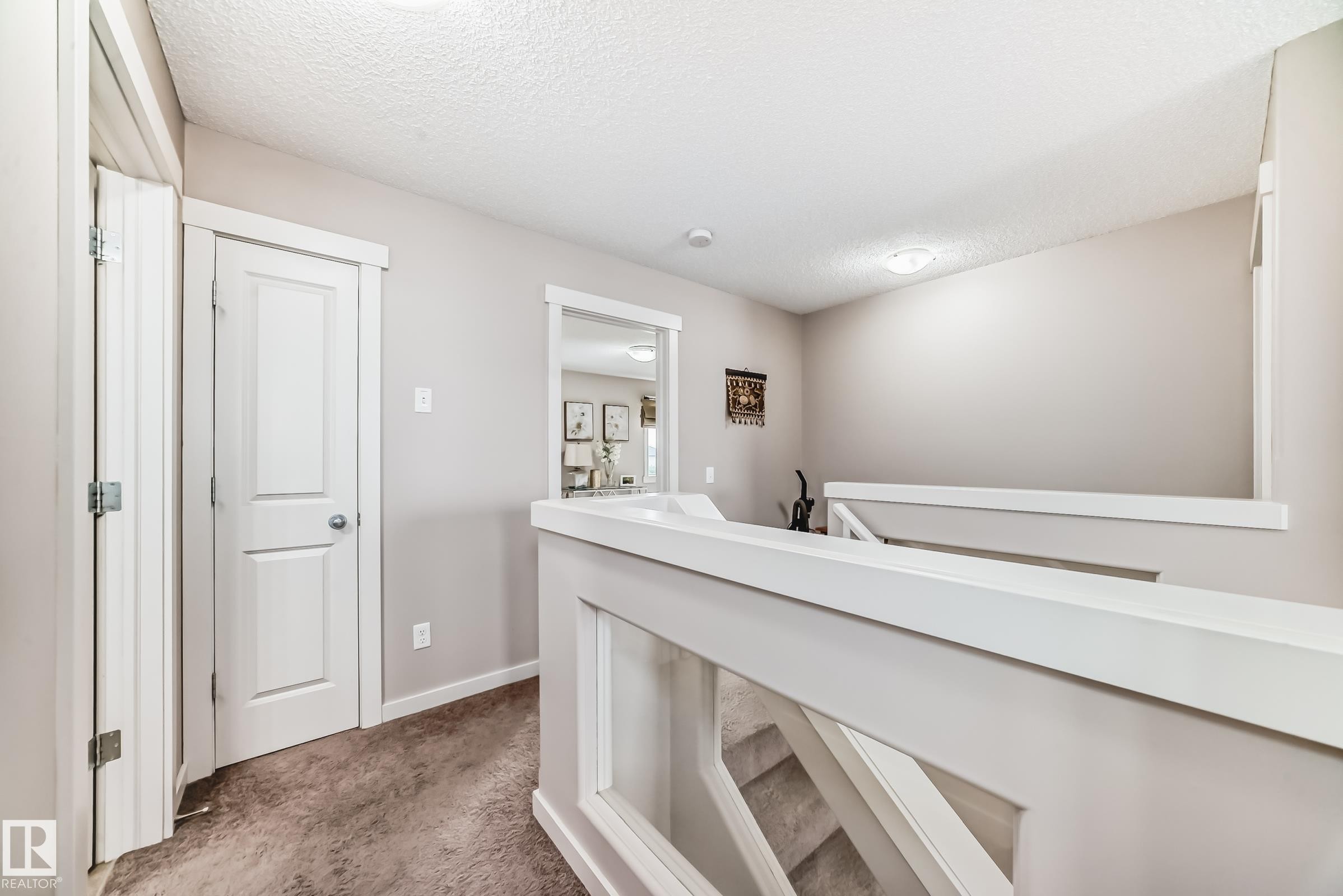 Upper landing featuring light gray painted walls and white trim - 2808 36 Avenue, Edmonton, AB