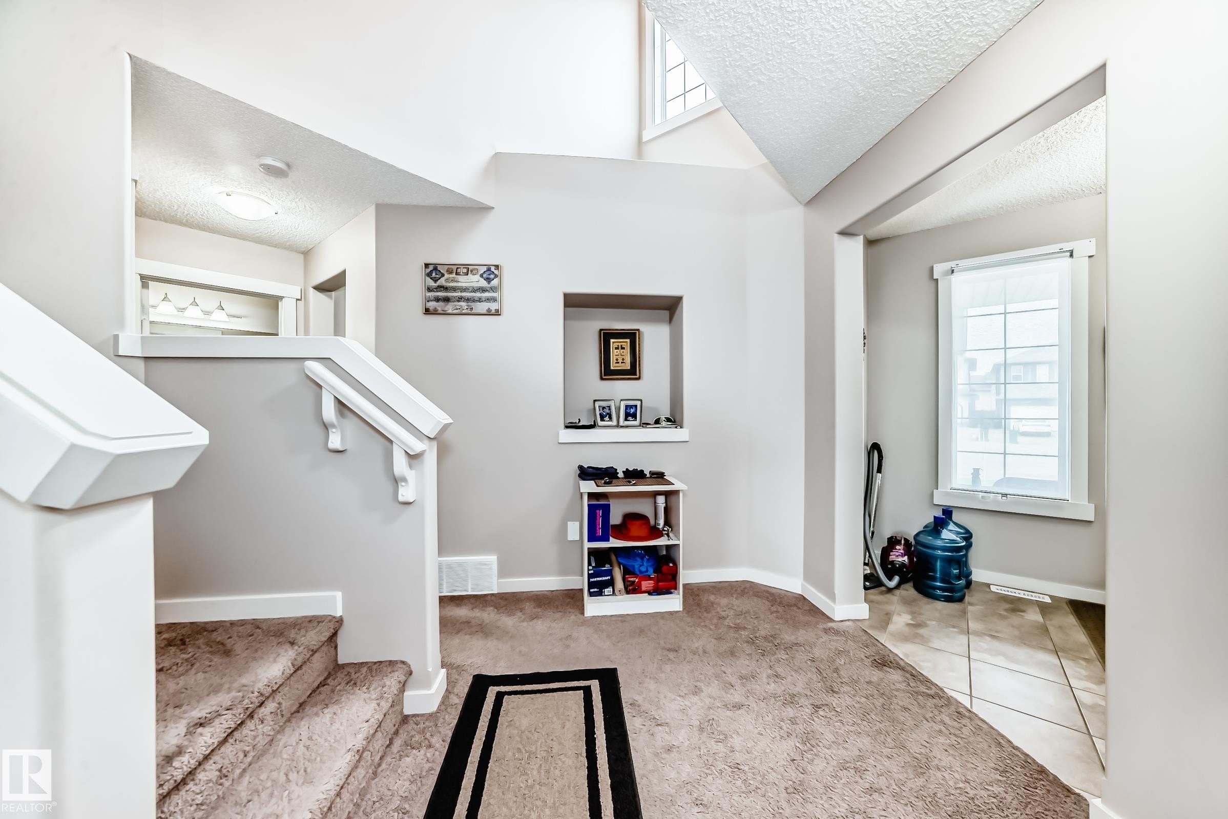 Split-level entry with carpeted stairs and white painted railings - 2808 36 Avenue, Edmonton, AB