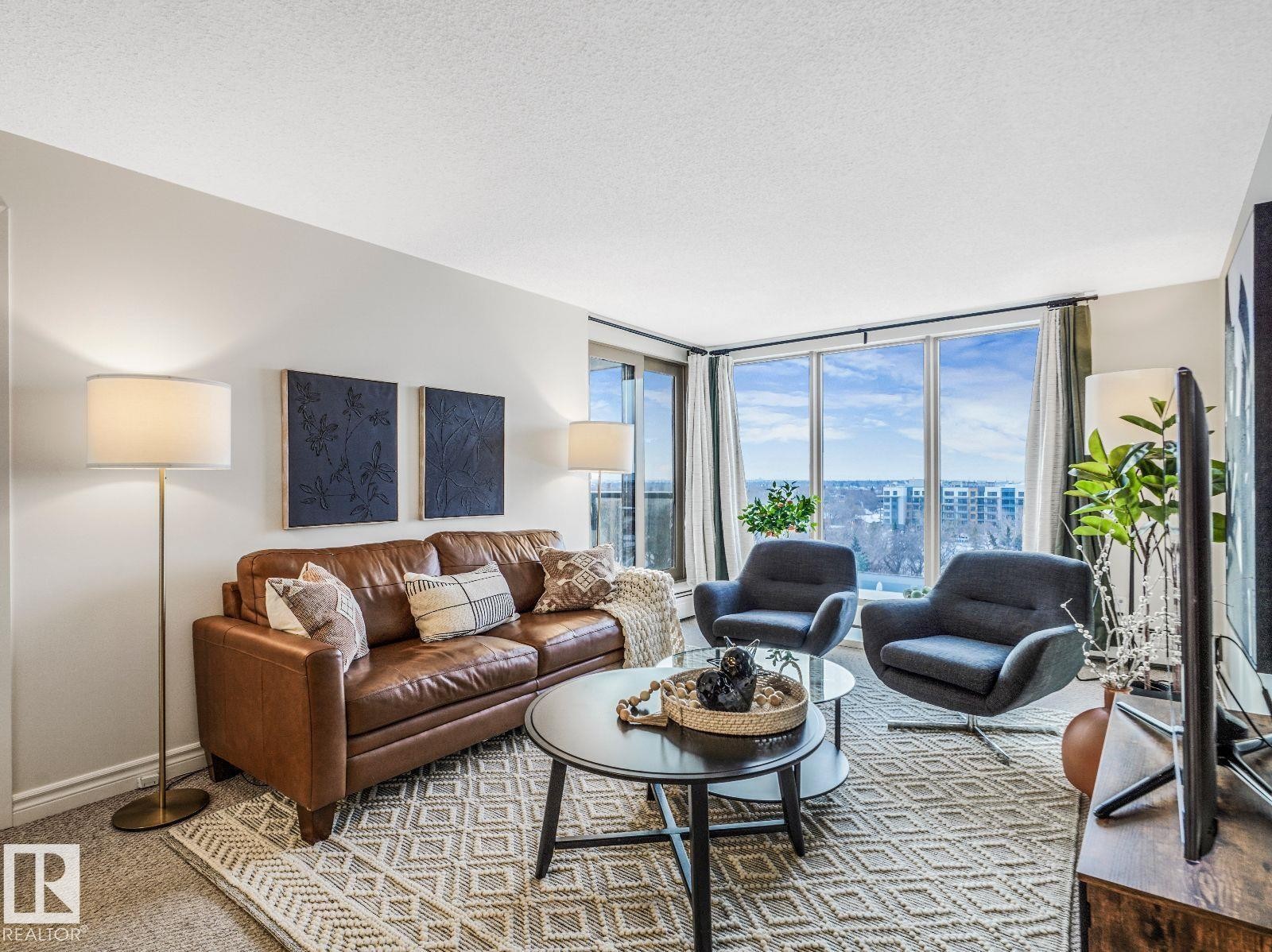 Living area featuring large windows with city and sky scenery - 806 10149 Saskatchewan Drive, Edmonton, AB