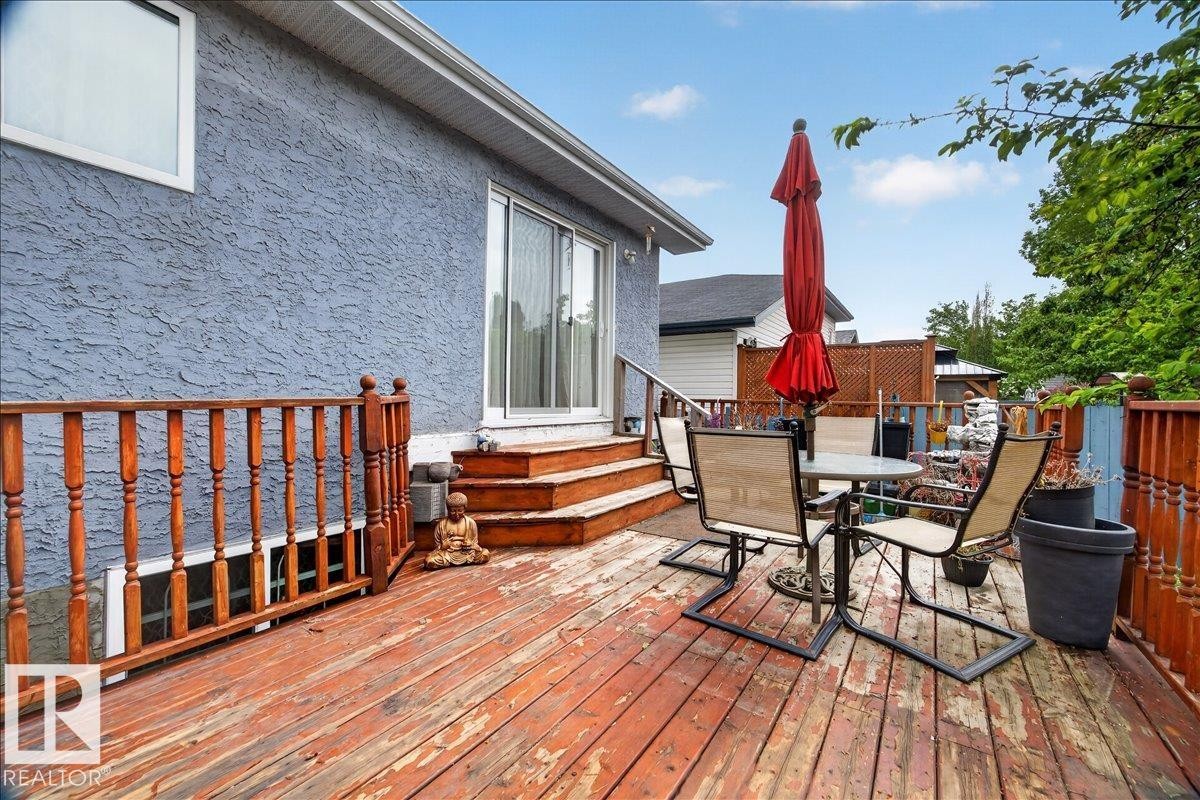 Spacious wooden deck with natural wood railing and privacy lattice - 5108 138A Avenue, Edmonton, AB