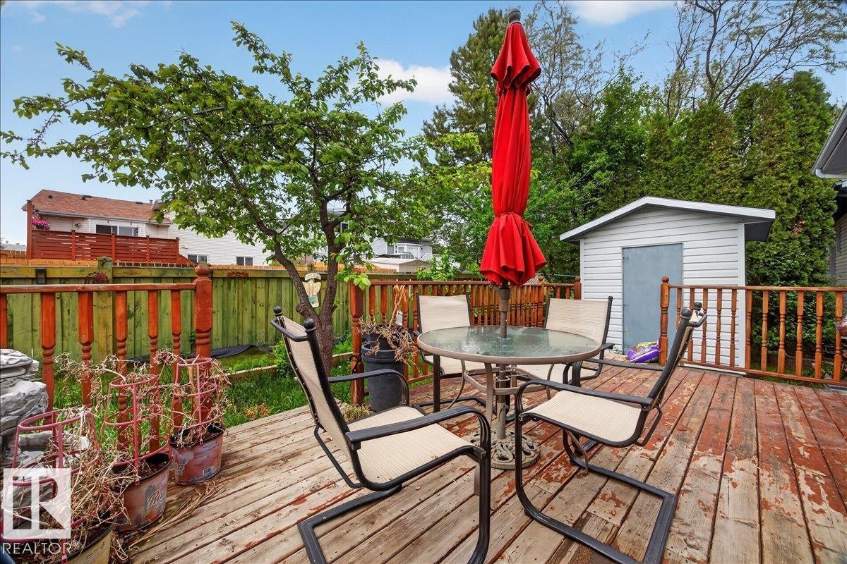 Expansive backyard deck featuring natural wood planks and a full wood privacy fence - 5108 138A Avenue, Edmonton, AB