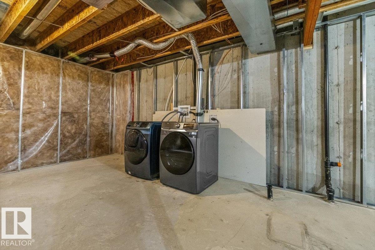 Unfinished basement space featuring exposed joists, concrete flooring, and insulated perimeter walls - 356 Pioneer Road, Spruce Grove, AB