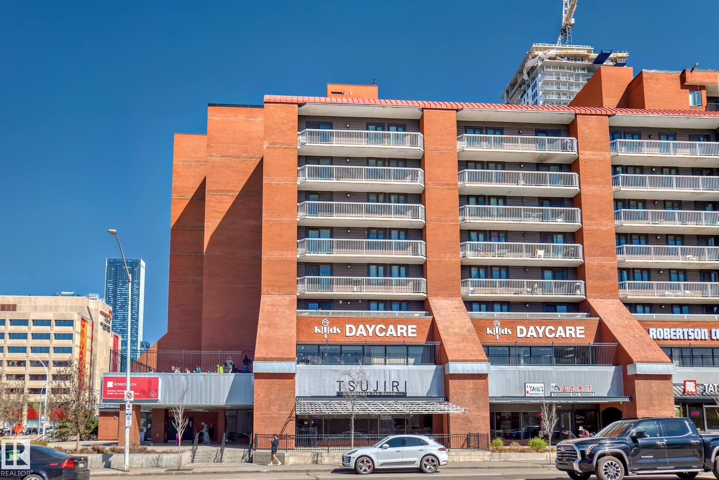 Multi-story building featuring a brick exterior with multiple balconies - #706 10125 109 St Nw, Edmonton, AB