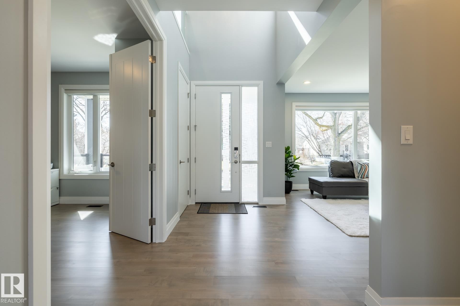 Foyer entrance with light wood-type flooring and recessed lighting - 10936 71 Avenue, Edmonton, AB