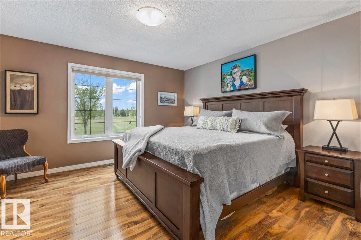 Window with exterior landscape, wood-finish flooring, and recessed ceiling lighting - 1086 Grantham Drive Nw, Edmonton, AB - Indoor Photo Showing Bedroom