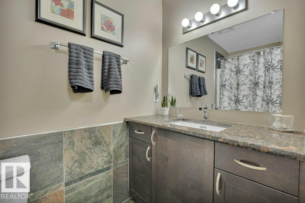 Main bathroom - 4-pc. with stacked laundry - 10 15151 43 Street, Edmonton, AB - Indoor Photo Showing Bathroom