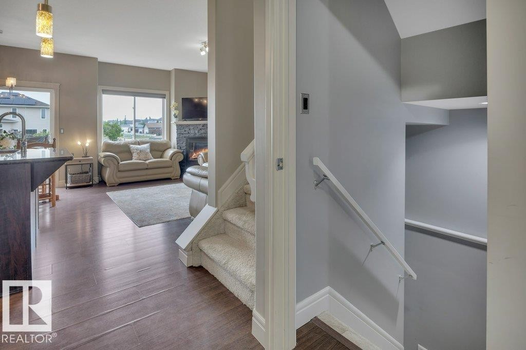 Main floor view looking to Great Room and stairs up to second floor + down to fully finished basement - 10 15151 43 Street, Edmonton, AB - Indoor Photo Showing Other Room