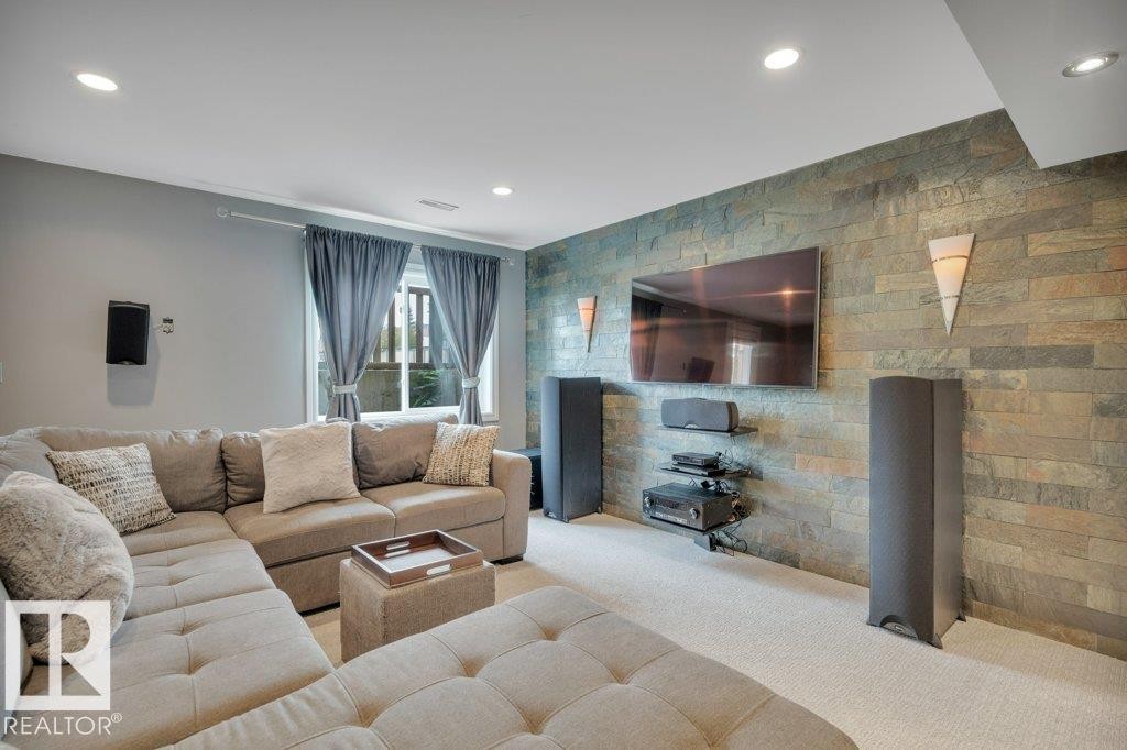 Finished basement - family room leading to walkout patio. Beautiful feature wall and plenty of natural light. - 10 15151 43 Street, Edmonton, AB - Indoor Photo Showing Living Room With Fireplace