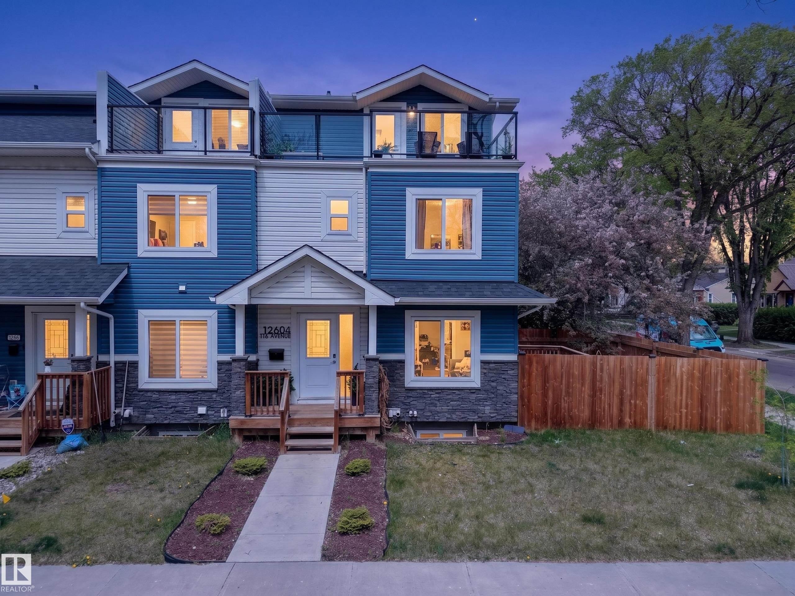Modern multi-level exterior featuring blue and white siding with stone-finish accents - 12604 116 Avenue, Edmonton, AB