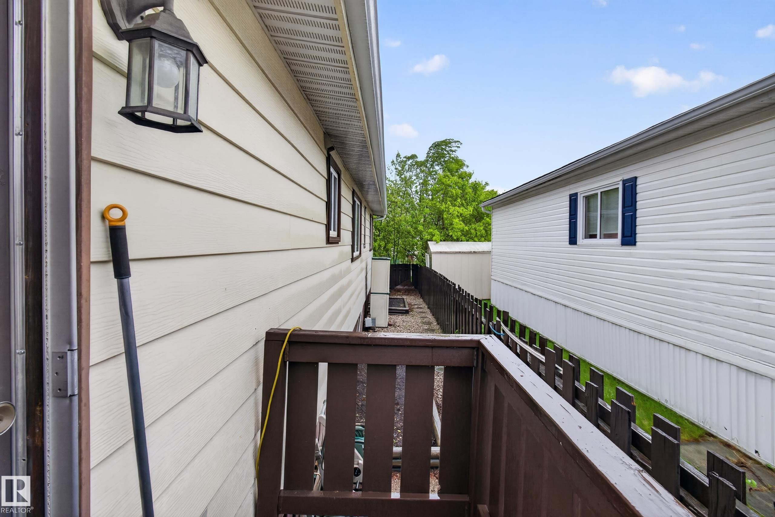 Exterior siding in a cream hue with brown trim windows - 21 Willowdale Drive, Edmonton, AB - Outdoor With Exterior