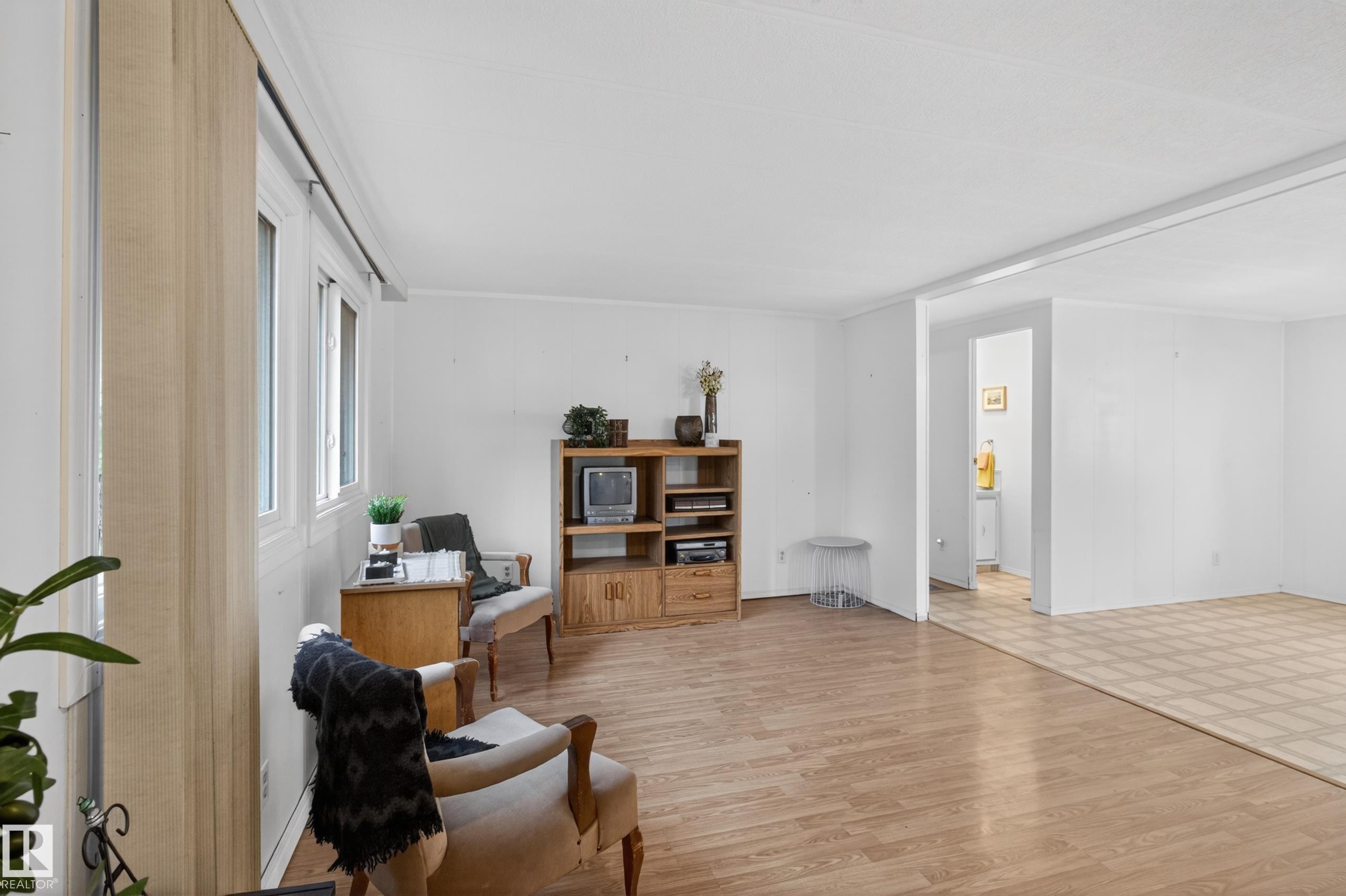 Bright interior featuring large windows, wood-finish flooring, and white walls - 21 Willowdale Drive, Edmonton, AB - Indoor