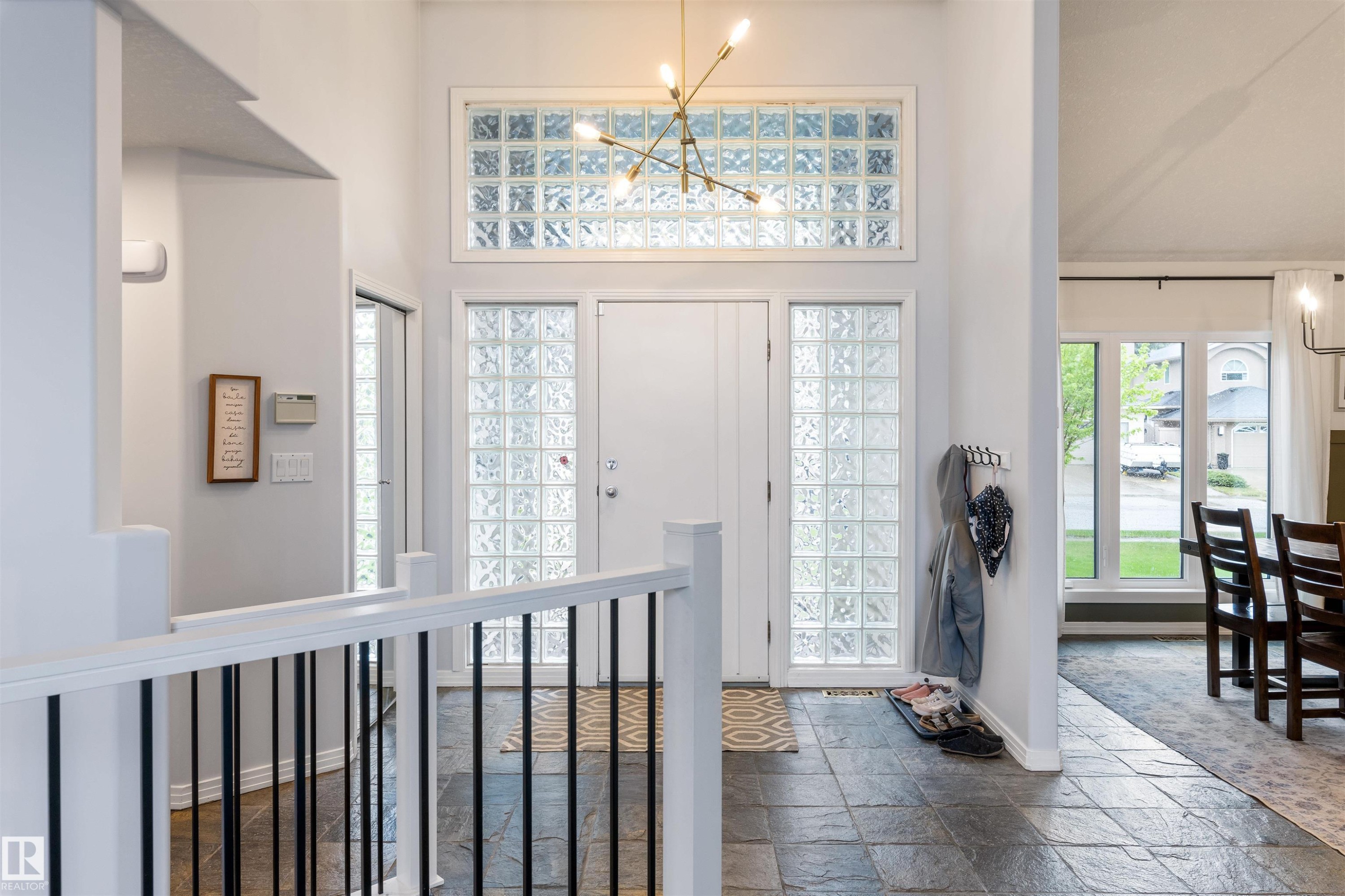 Entryway featuring slate tile flooring and a white front door flanked by glass block sidelights - 10 Everest Crescent, St. Albert, AB