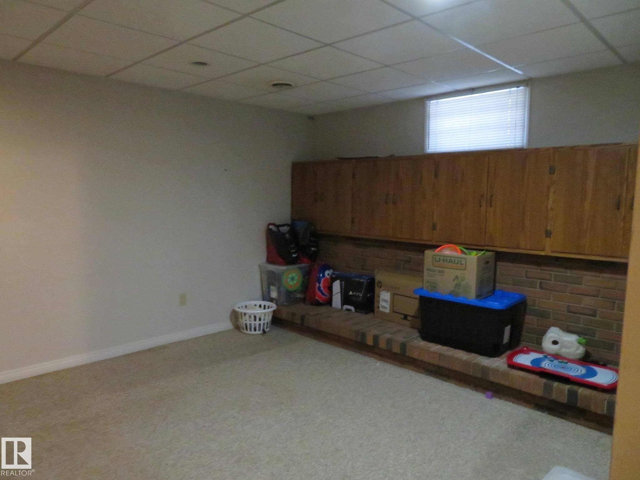 Room featuring wall-to-wall carpeting and white painted walls - 10720 57 Avenue Nw, Edmonton, AB - Indoor Photo Showing Basement