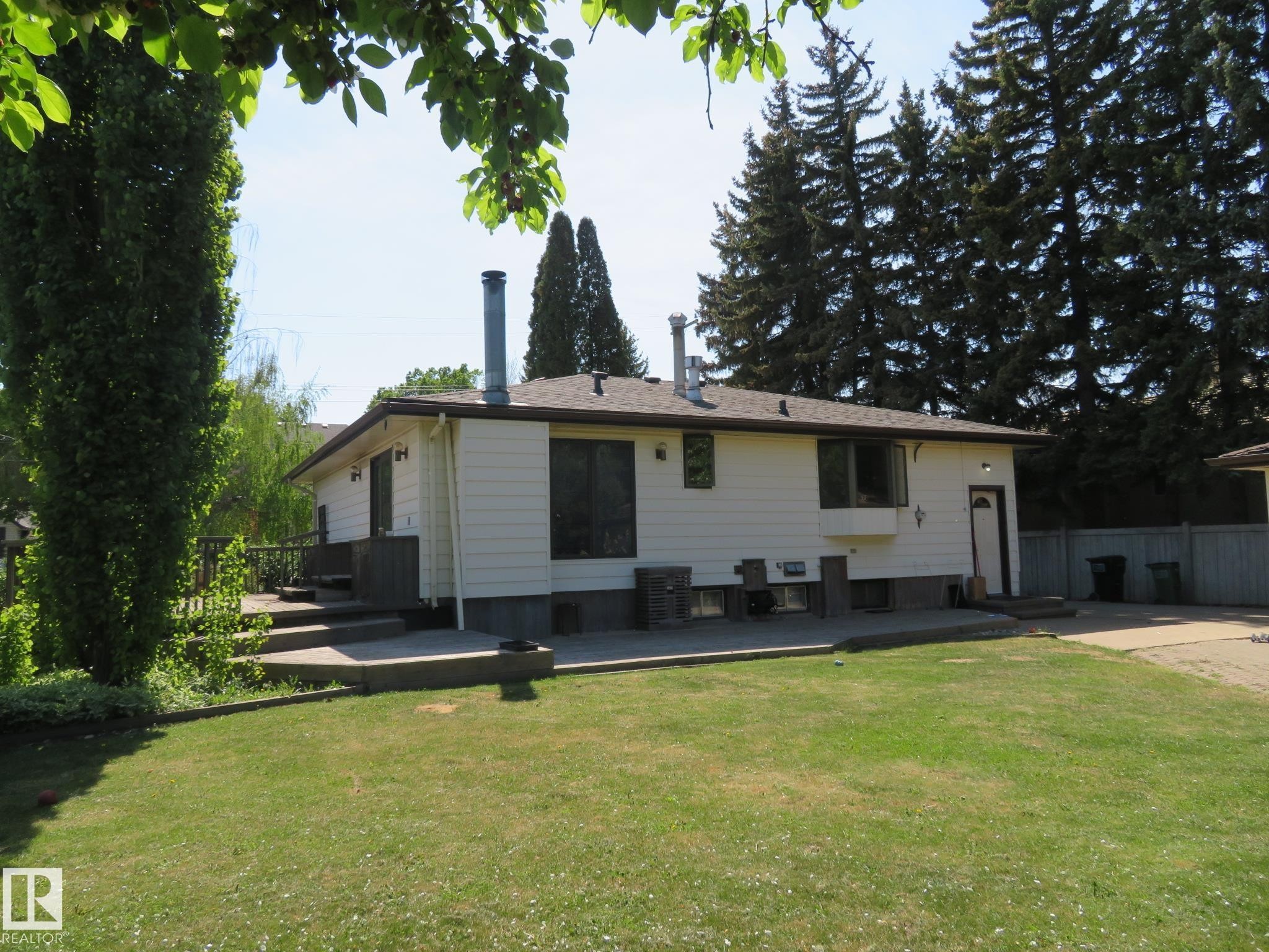 Exterior featuring white siding, a dark shingle roof, and multiple windows - 10720 57 Avenue Nw, Edmonton, AB - Outdoor