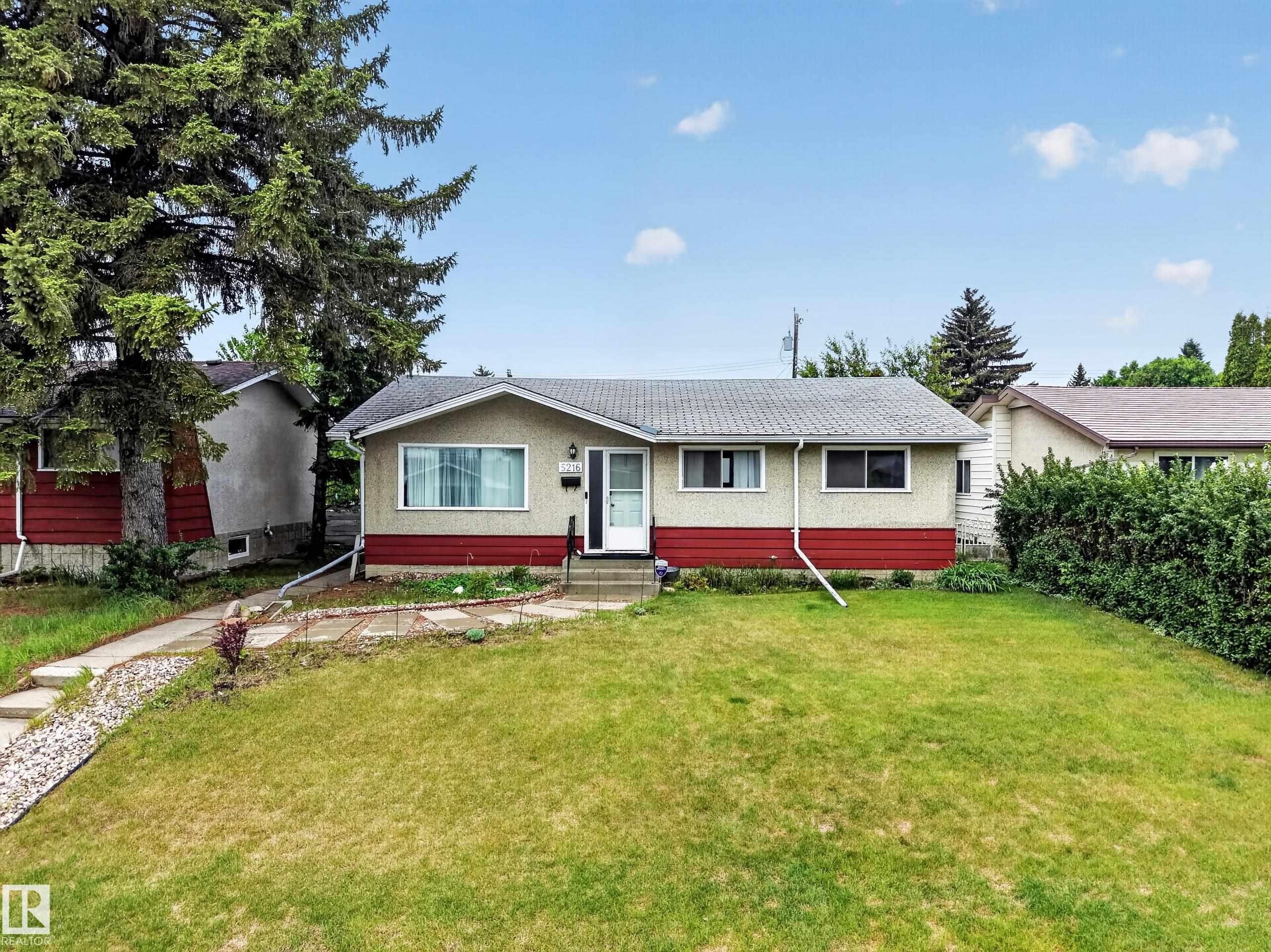 Ranch-style exterior with a stucco and horizontal panel facade - 5216 104A Street, Edmonton, AB - Outdoor