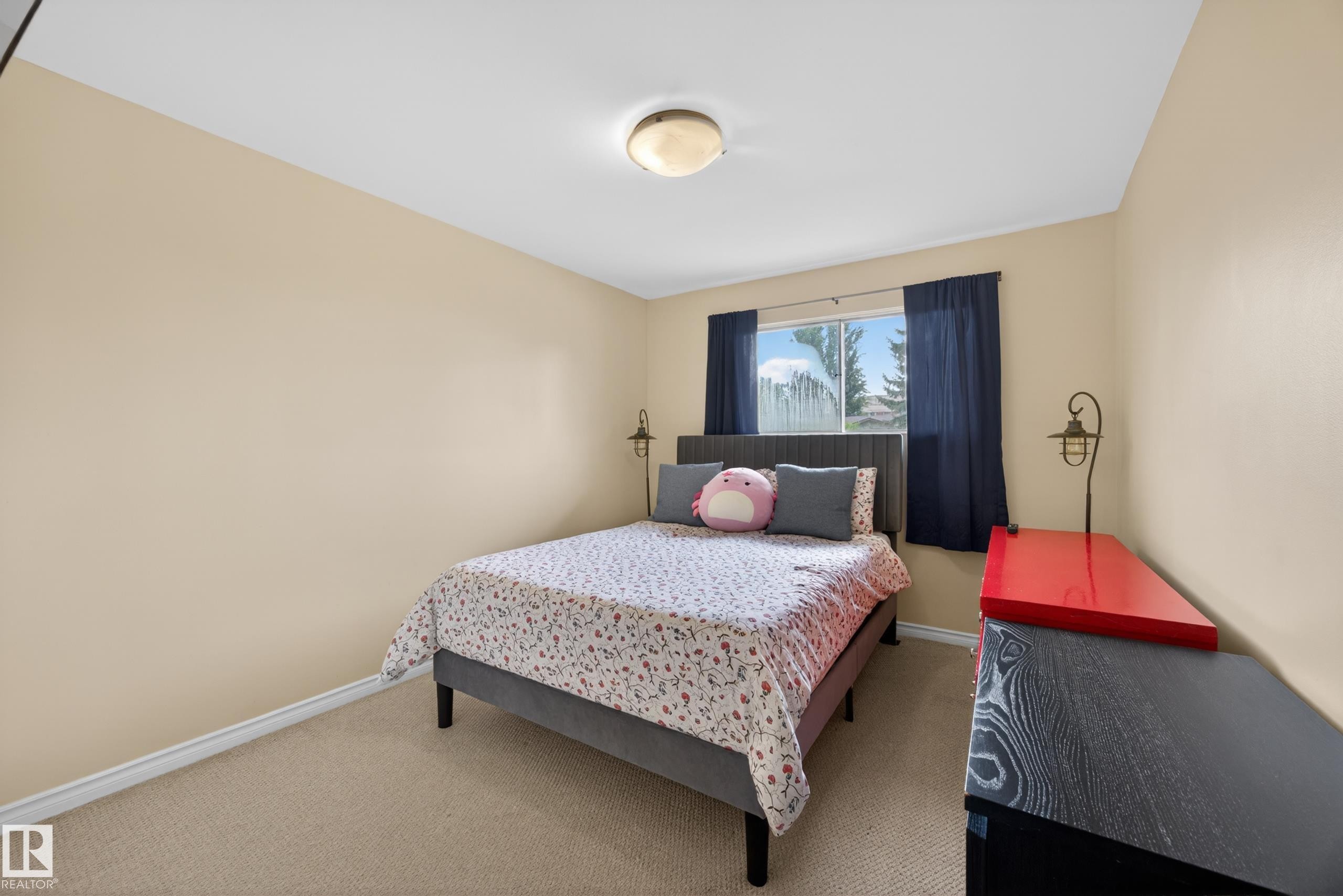 Bedroom featuring carpet flooring, neutral-toned walls, and a window with a distant landscape - 5216 104A Street, Edmonton, AB - Indoor Photo Showing Bedroom