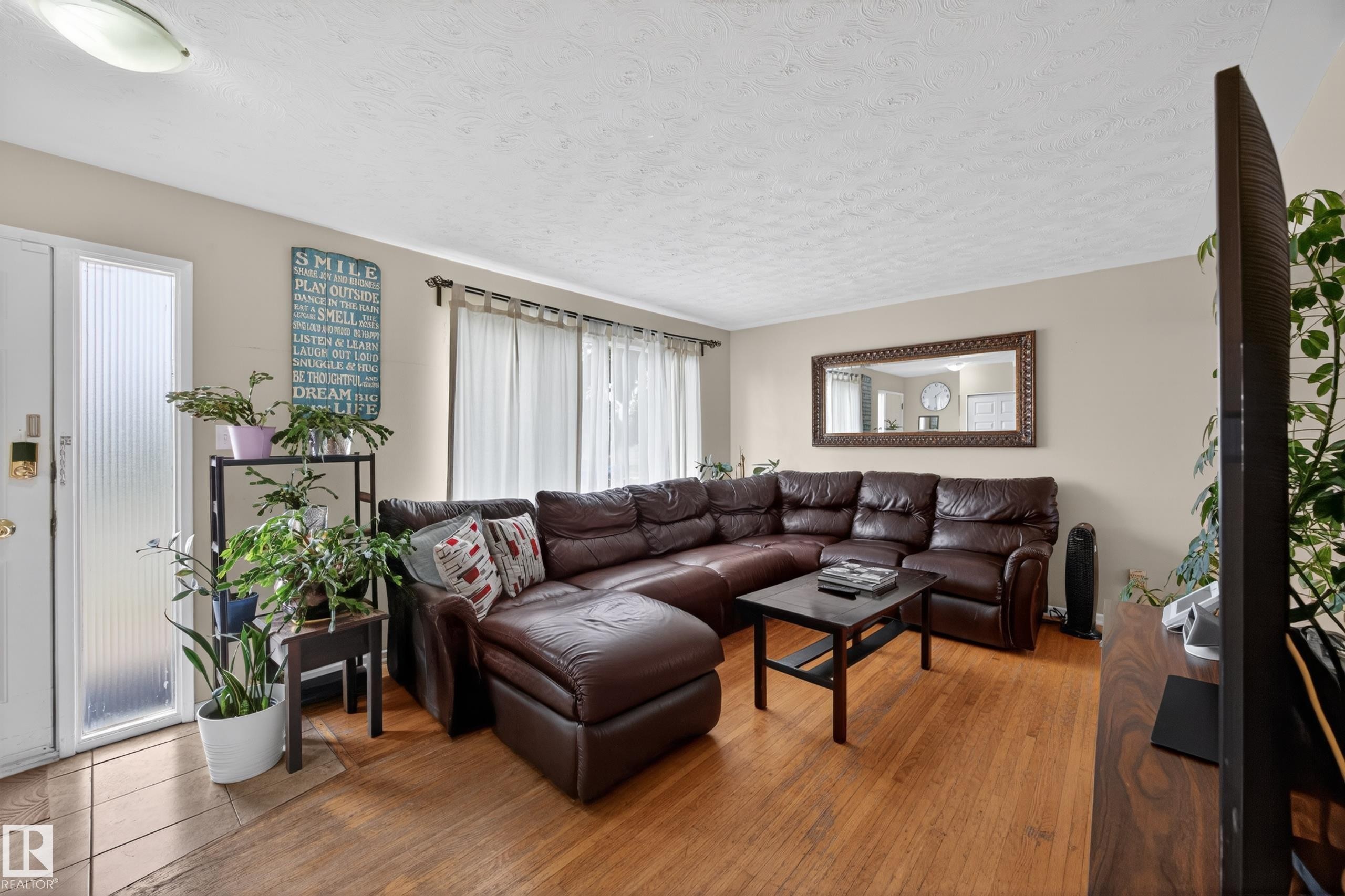 Living space featuring wood-finish flooring, neutral wall tones, and recessed lighting - 5216 104A Street, Edmonton, AB - Indoor Photo Showing Living Room