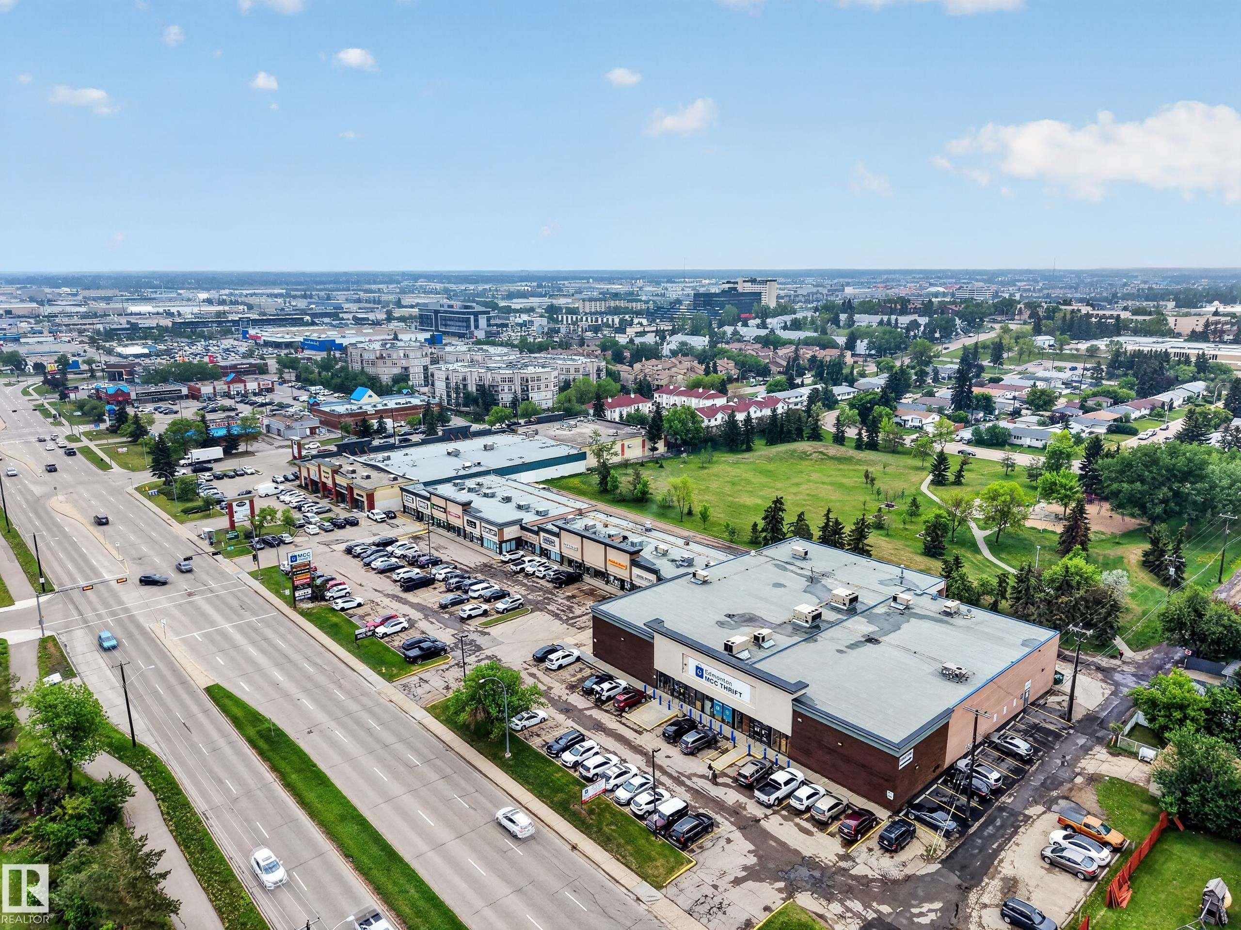 Expansive commercial property featuring multiple retail storefronts with ample surface parking - 5216 104A Street, Edmonton, AB - Outdoor With View