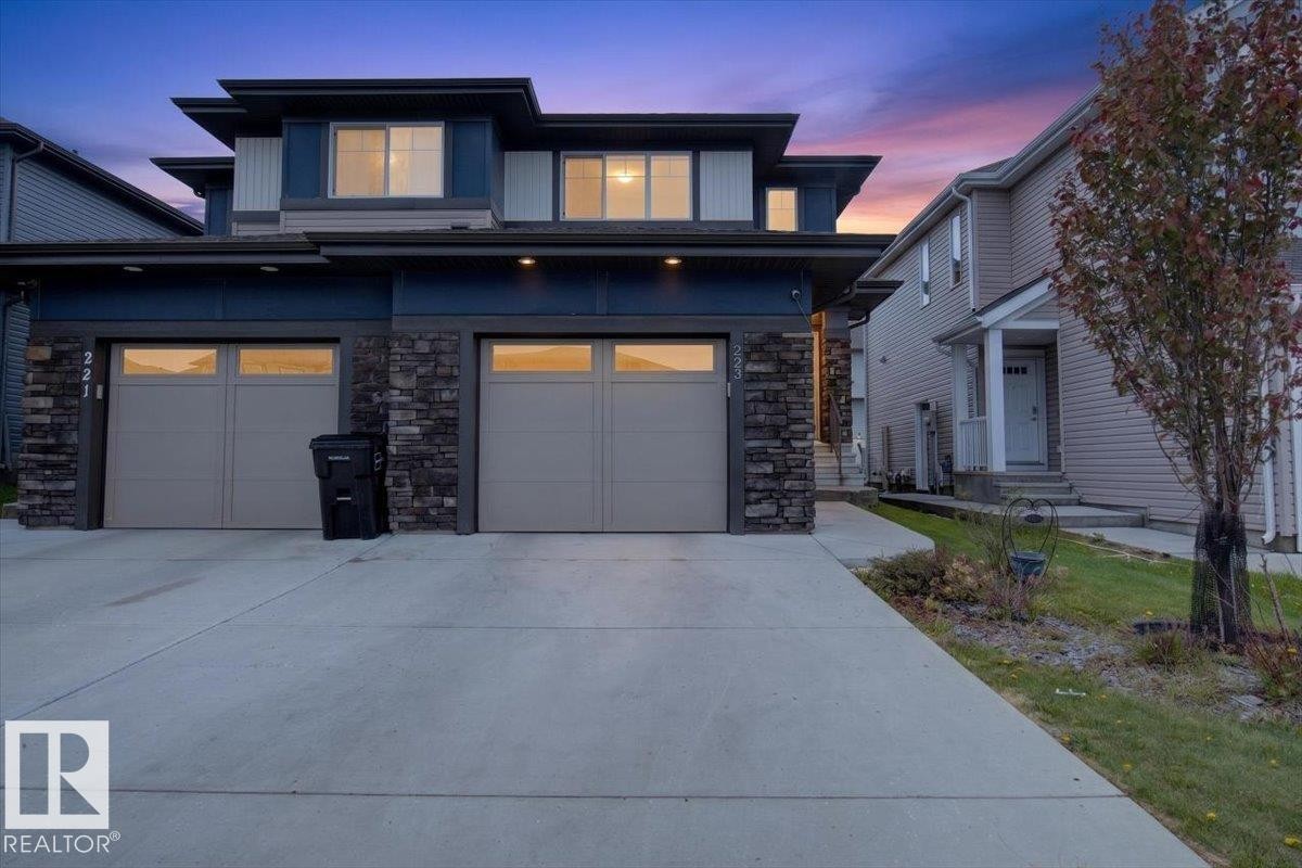 Modern exterior with stacked stone accents, dark siding, and a multi-level roofline - 223 40A Avenue, Edmonton, AB - Outdoor With Facade