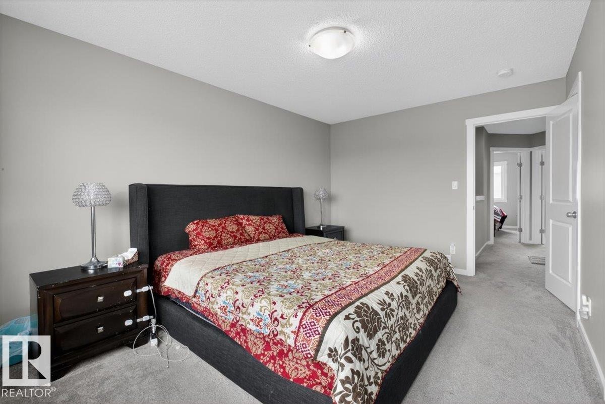 Carpeted bedroom featuring light gray walls, a white ceiling, and a white flush-mount ceiling light fixture - 223 40A Avenue, Edmonton, AB - Indoor Photo Showing Bedroom