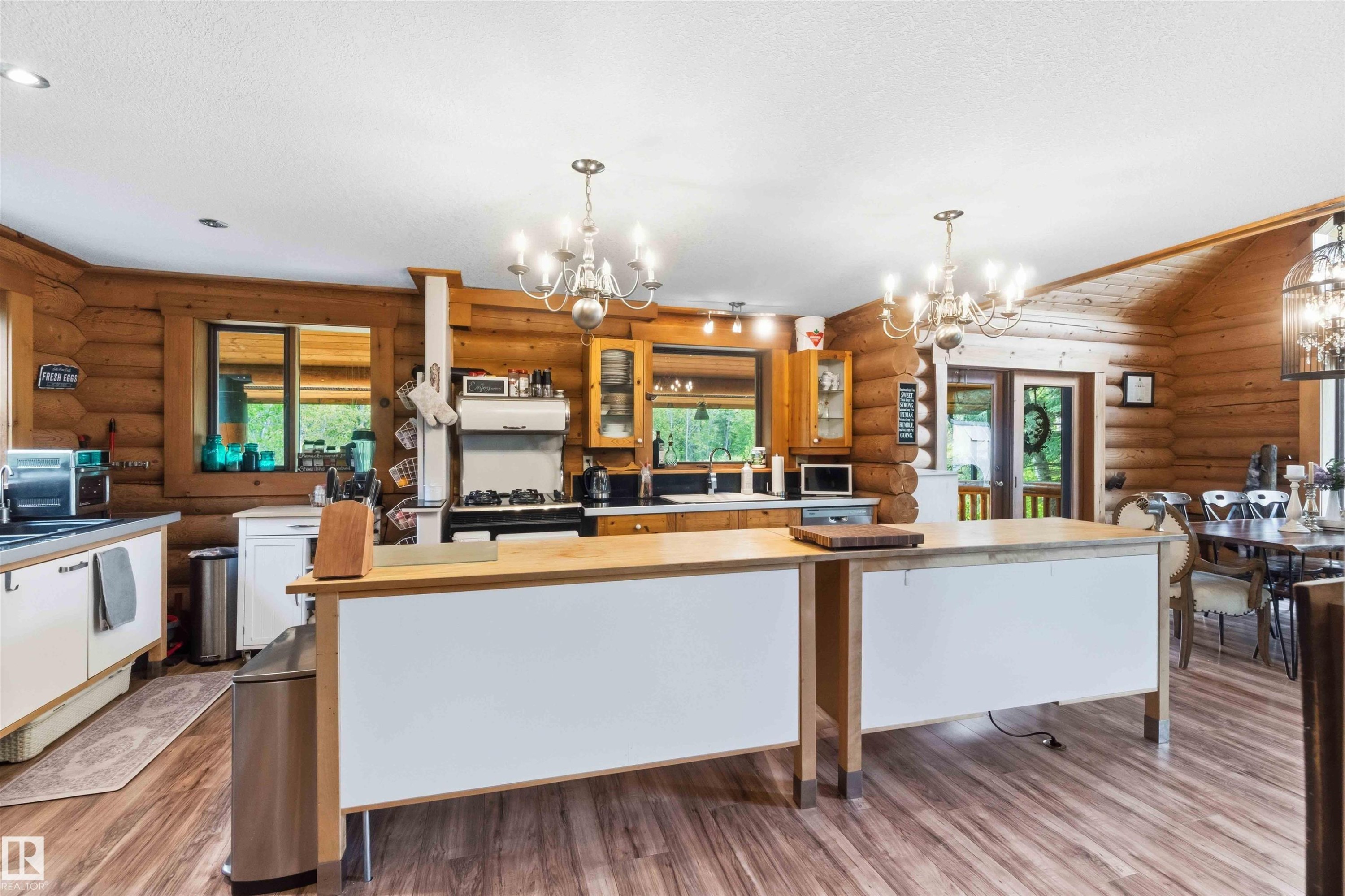 Kitchen featuring wood-finish flooring, log walls, and white ceiling with recessed lighting - #17 A 15031 Twp Road 462, Rural Wetaskiwin County, AB - Indoor Photo Showing Kitchen