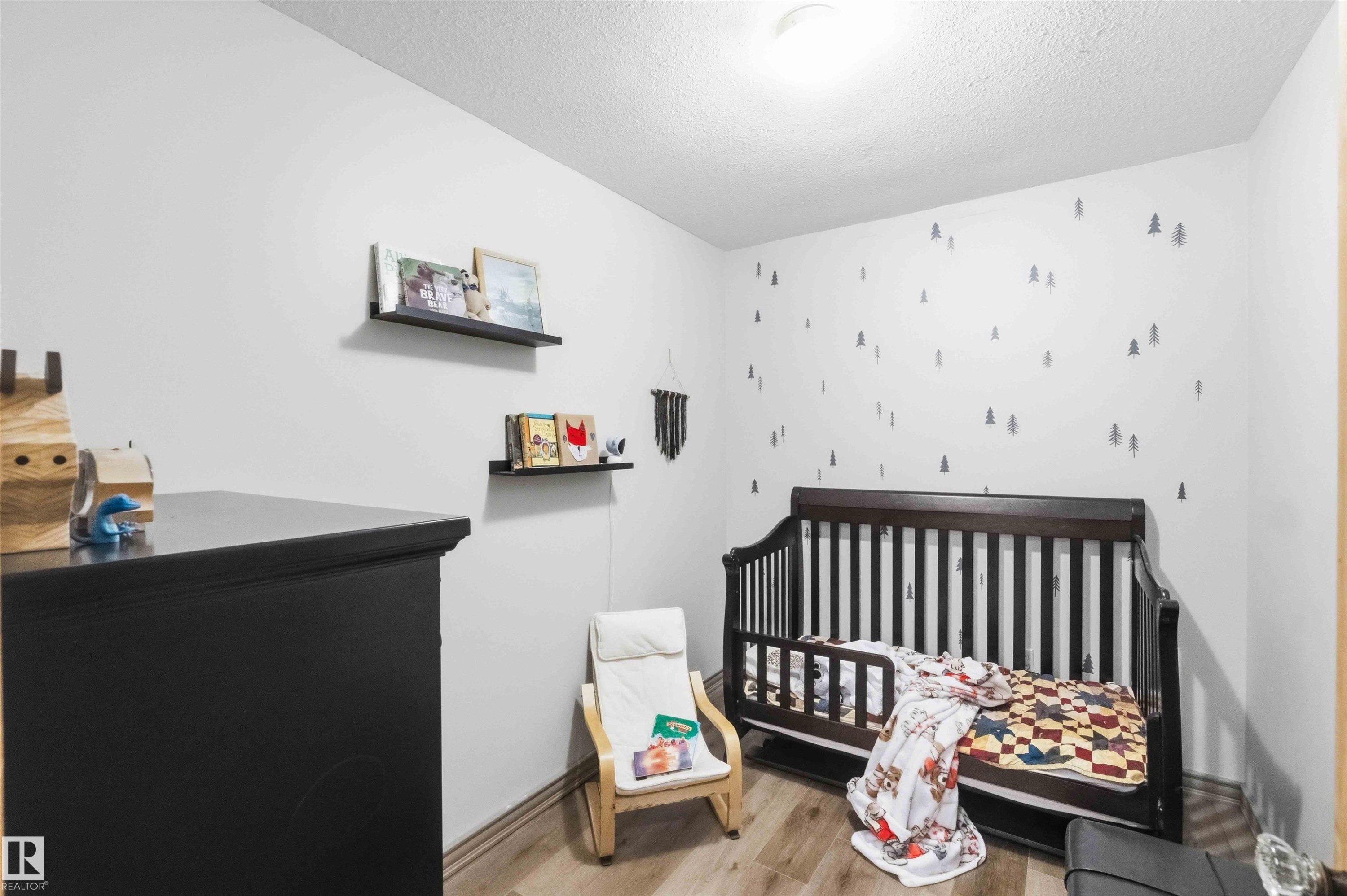 White walls with decorative wall decals, wood-finish flooring, recessed lighting, and floating wall shelves - #17 A 15031 Twp Road 462, Rural Wetaskiwin County, AB - Indoor