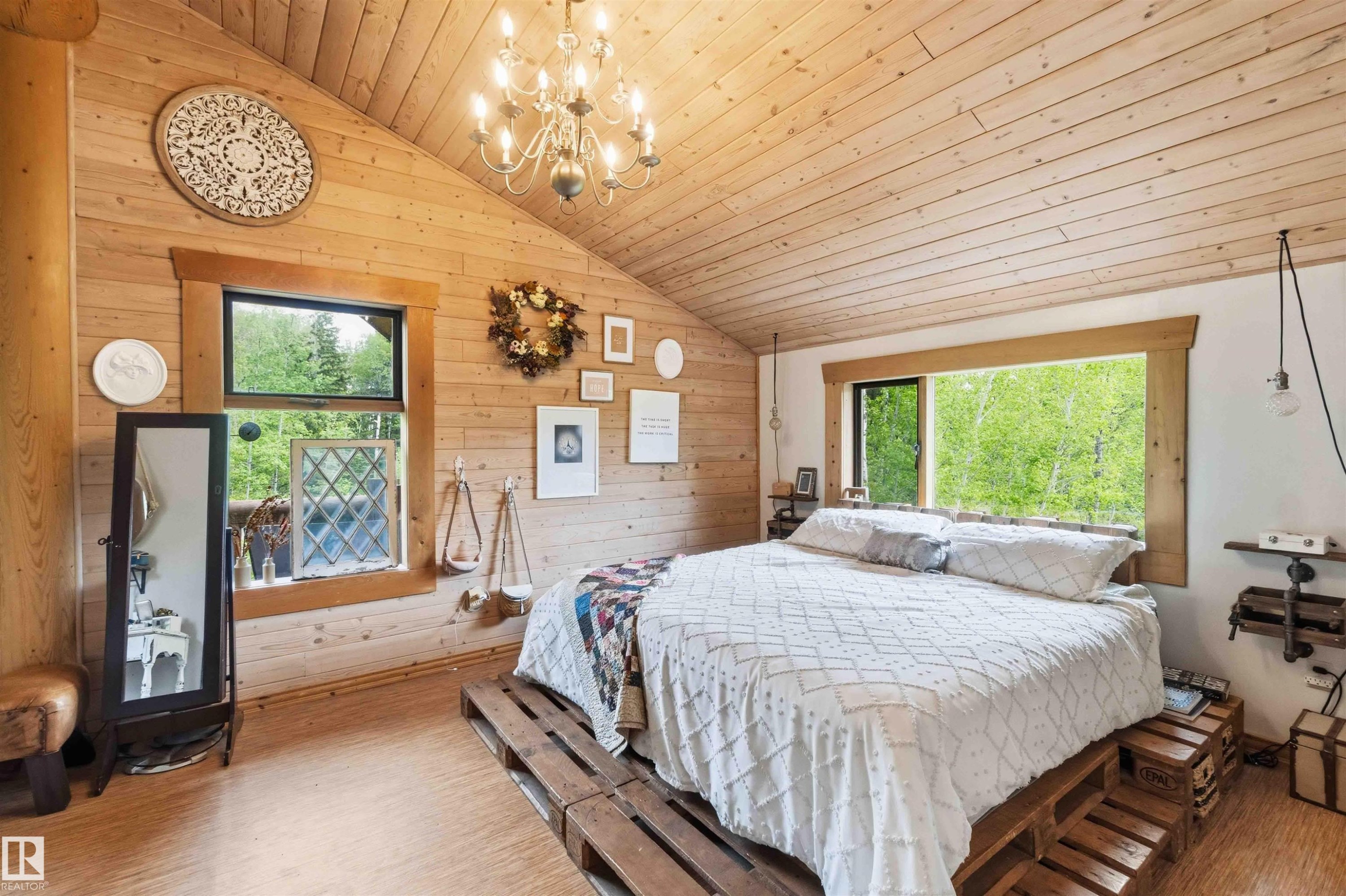 Wood-paneled bedroom featuring an angled ceiling and wood-finish flooring - #17 A 15031 Twp Road 462, Rural Wetaskiwin County, AB - Indoor Photo Showing Other Room