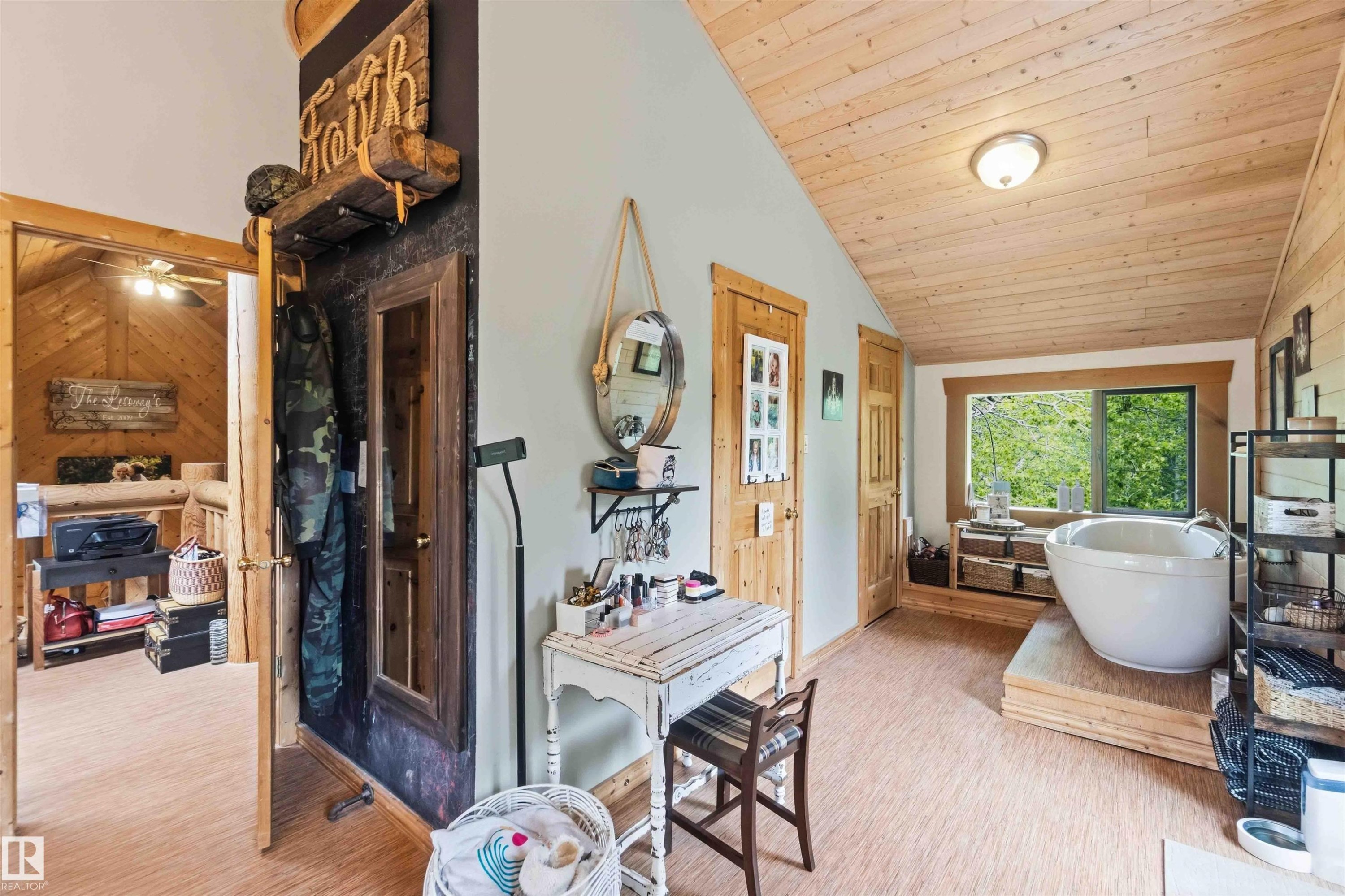 Bathroom featuring a freestanding soaking tub on a wood platform - #17 A 15031 Twp Road 462, Rural Wetaskiwin County, AB - Indoor