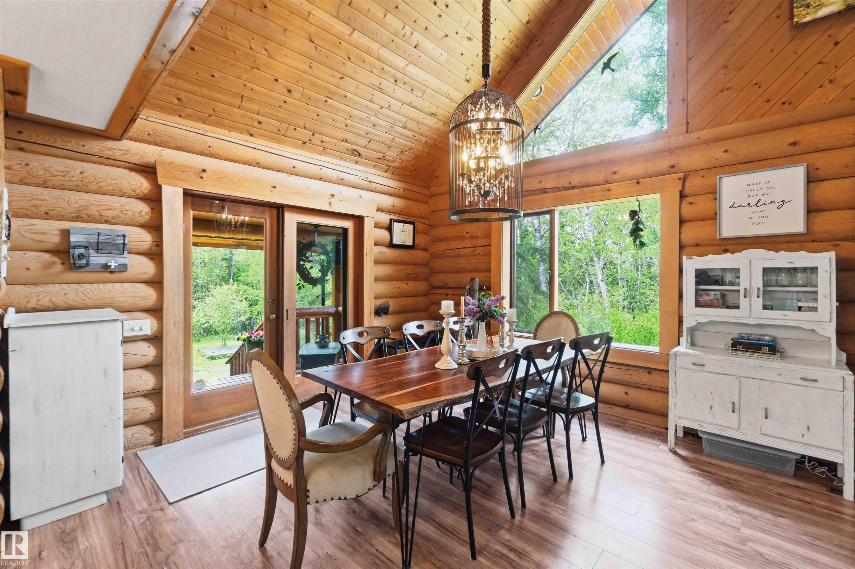 Dining area featuring log walls, wood-finish flooring, a built-in wood ceiling, transom windows, and double French doors providing exterior access - #17 A 15031 Twp Road 462, Rural Wetaskiwin County, AB - Indoor