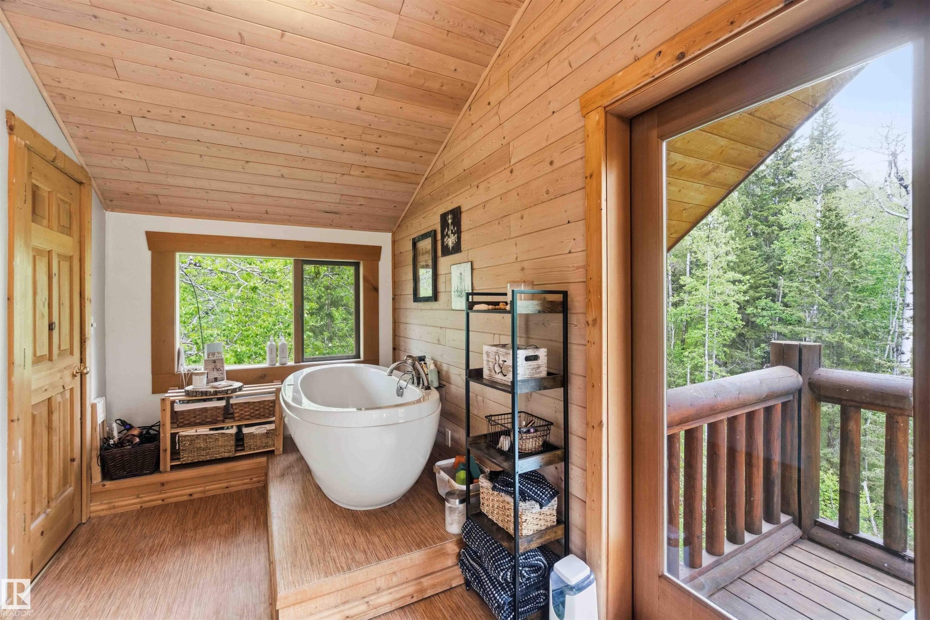 Freestanding soaking tub on a raised wood platform, with wood-paneled walls and ceiling - #17 A 15031 Twp Road 462, Rural Wetaskiwin County, AB -