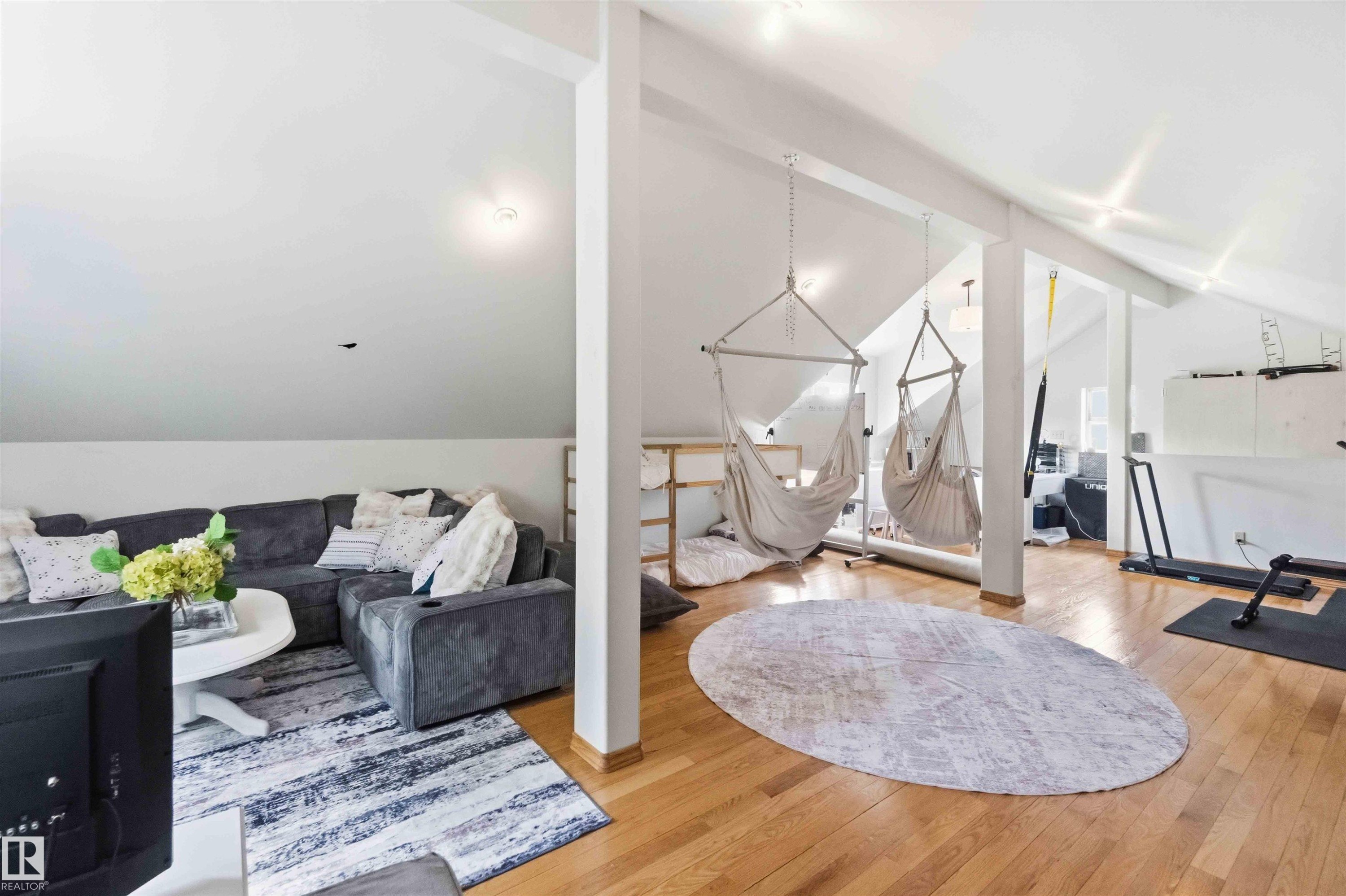 Spacious loft area featuring vaulted ceilings, exposed beams, and light wood-finish flooring - #17 A 15031 Twp Road 462, Rural Wetaskiwin County, AB - Indoor