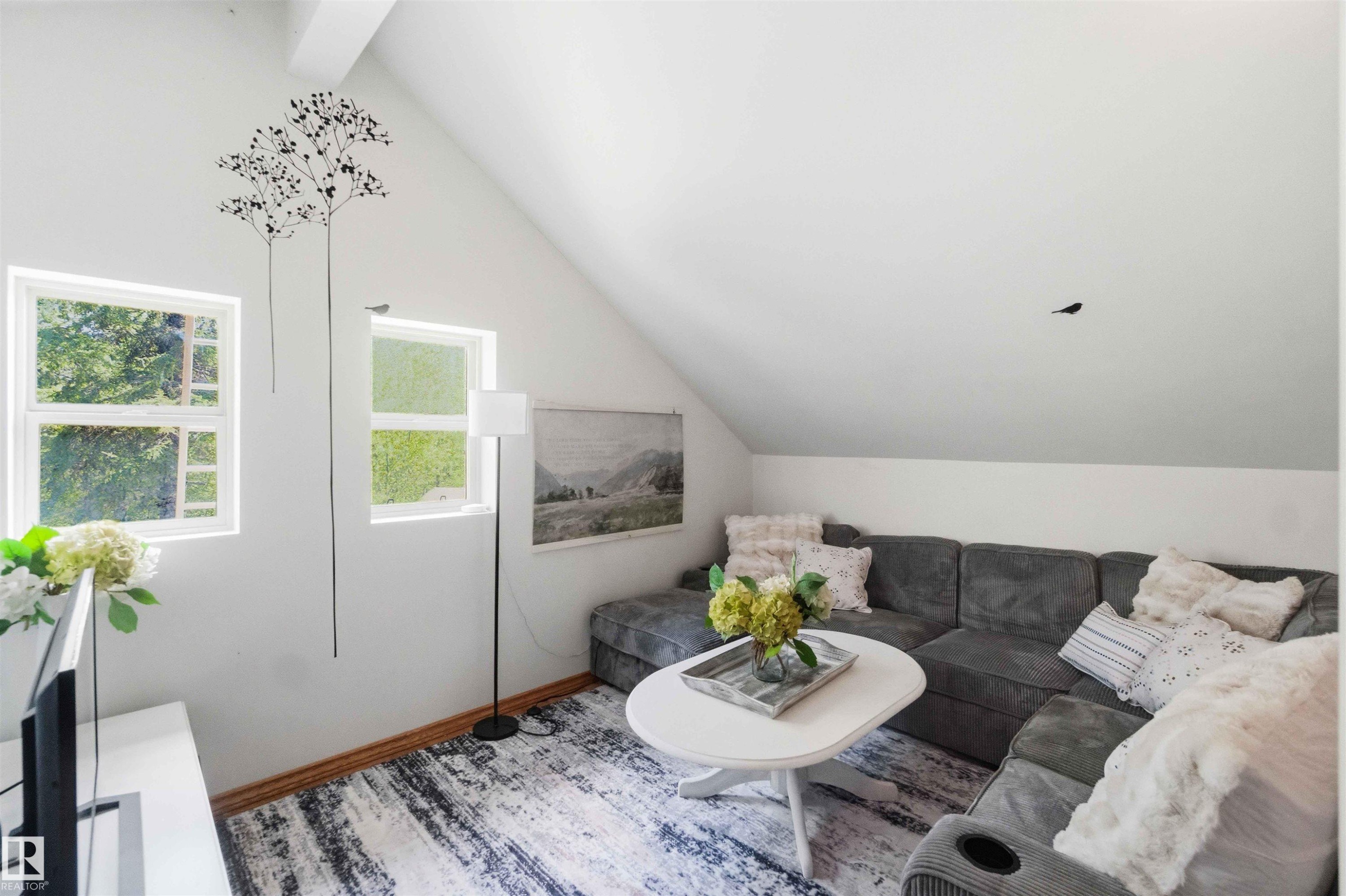 Attic living space featuring dual windows, vaulted ceilings, and wood-finish flooring - #17 A 15031 Twp Road 462, Rural Wetaskiwin County, AB - Indoor