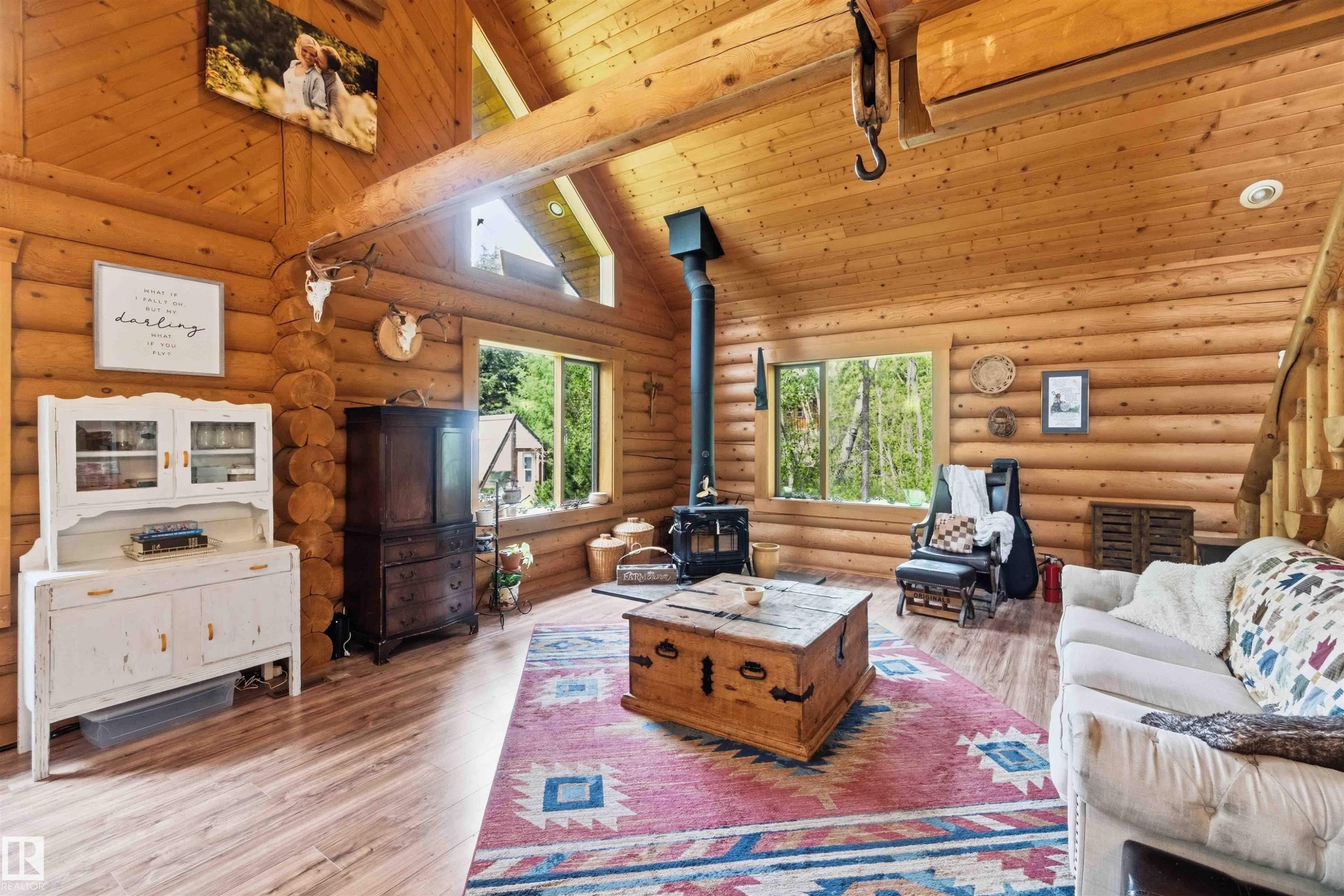 Spacious living area featuring log walls, vaulted wood ceilings with exposed beams, and wood-finish flooring - #17 A 15031 Twp Road 462, Rural Wetaskiwin County, AB - Indoor Photo Showing Dining Room