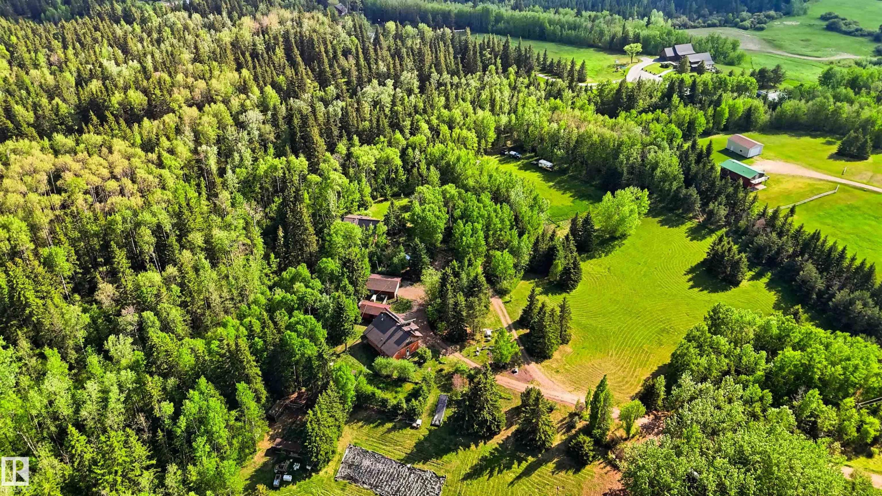 Expansive treed acreage featuring a residence with a brown roof and a detached outbuilding - #17 A 15031 Twp Road 462, Rural Wetaskiwin County, AB - Outdoor