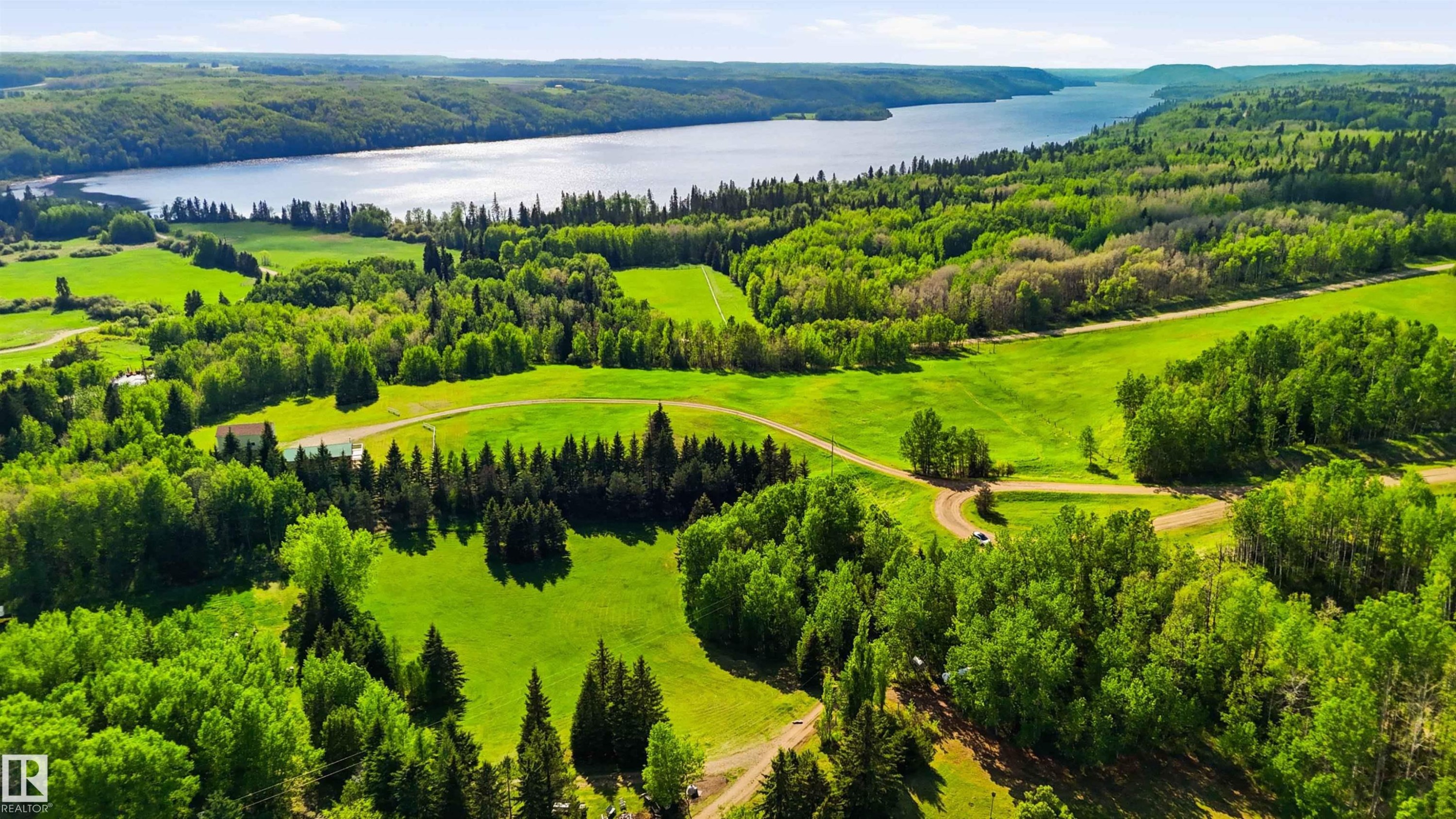 Expansive acreage featuring abundant mature trees, open grassy areas, and a visible body of water - #17 A 15031 Twp Road 462, Rural Wetaskiwin County, AB - Outdoor With Body Of Water With View