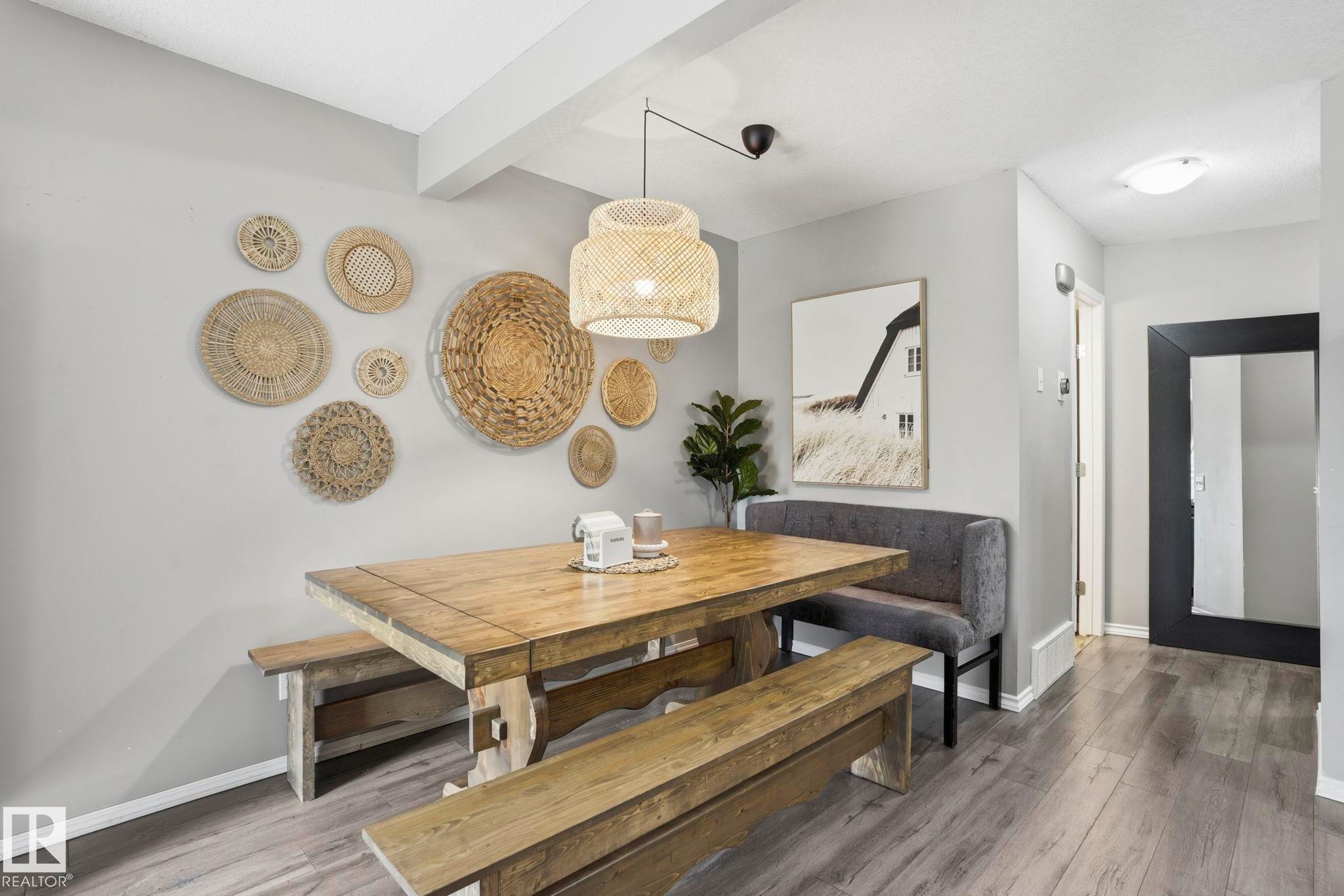 Dining area featuring wood-finish flooring and light gray walls - 164 150 Edwards Drive, Edmonton, AB - Indoor Photo Showing Other Room