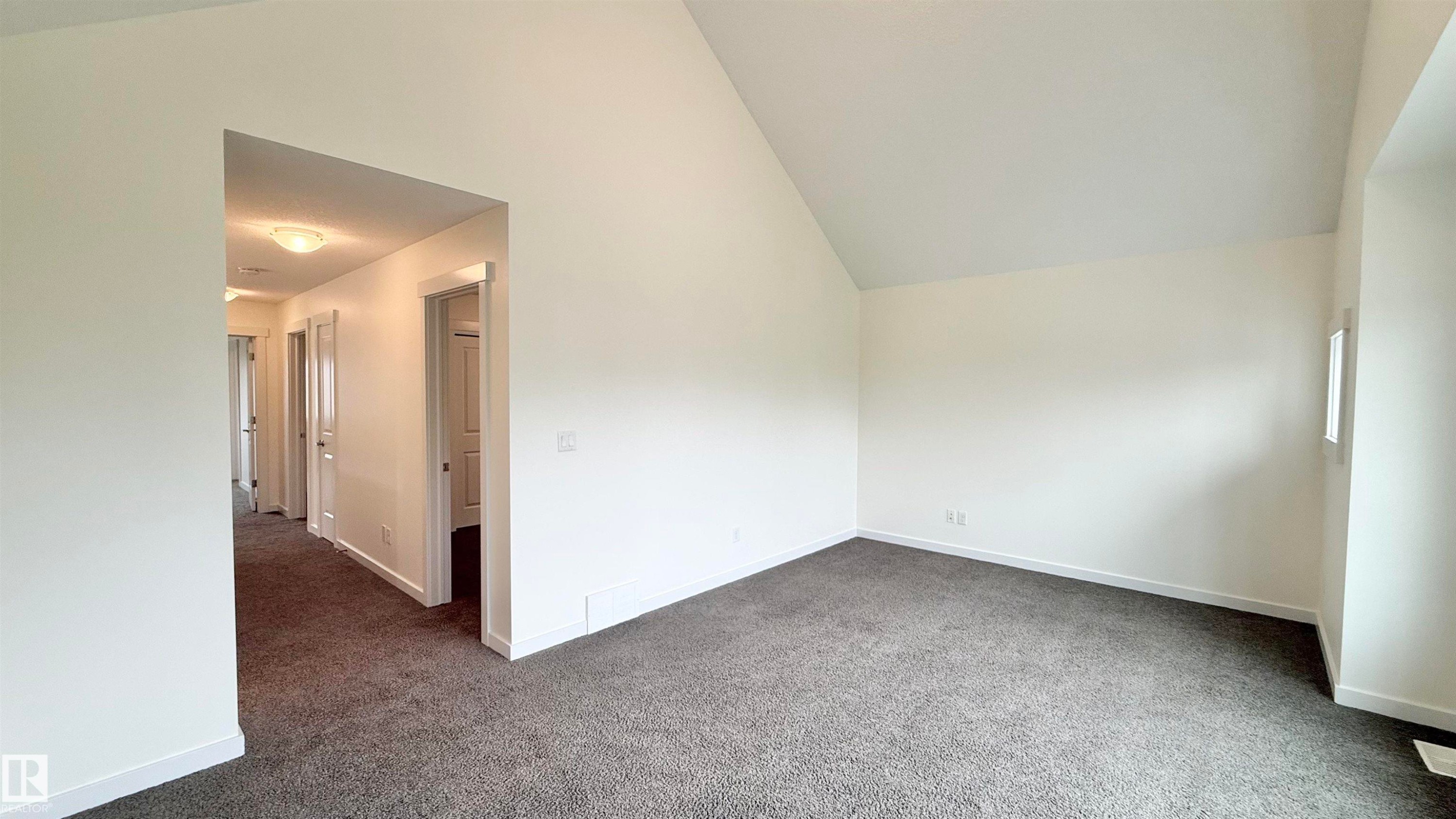 Room featuring vaulted ceilings and neutral-toned carpeting - 3962 Claxton Loop, Edmonton, AB - Indoor Photo Showing Other Room