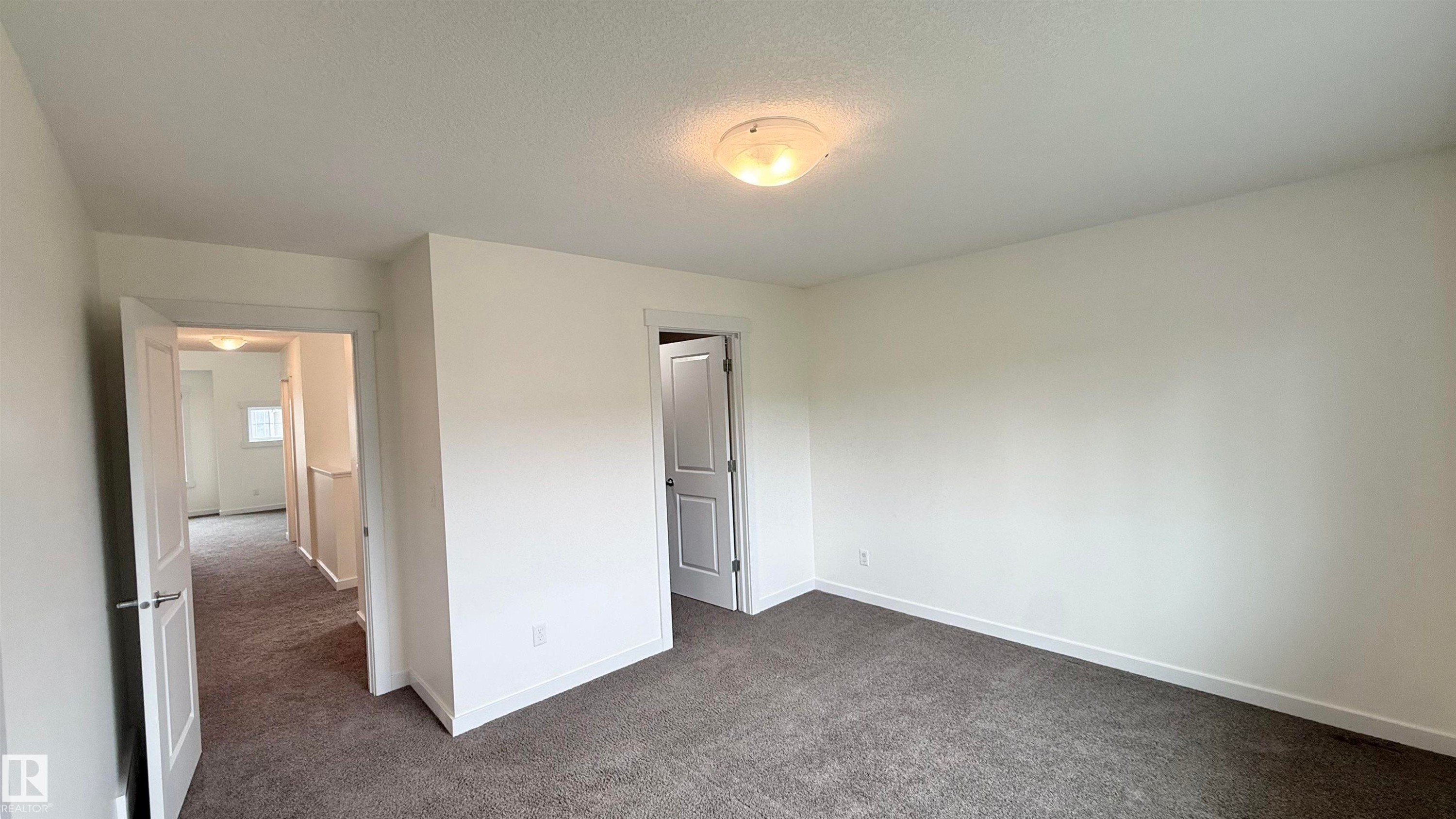 Bedroom featuring neutral-toned carpeting, white walls, and a semi-flush ceiling light fixture - 3962 Claxton Loop, Edmonton, AB - Indoor Photo Showing Other Room