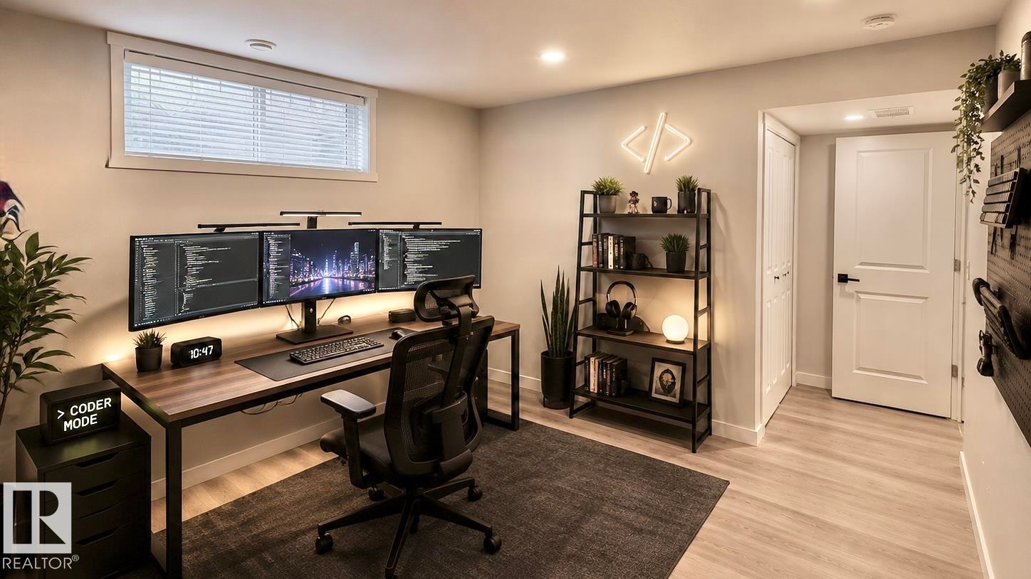 Dedicated workspace featuring wood-finish flooring, recessed lighting, and a modern desk setup - 3962 Claxton Loop, Edmonton, AB - Indoor