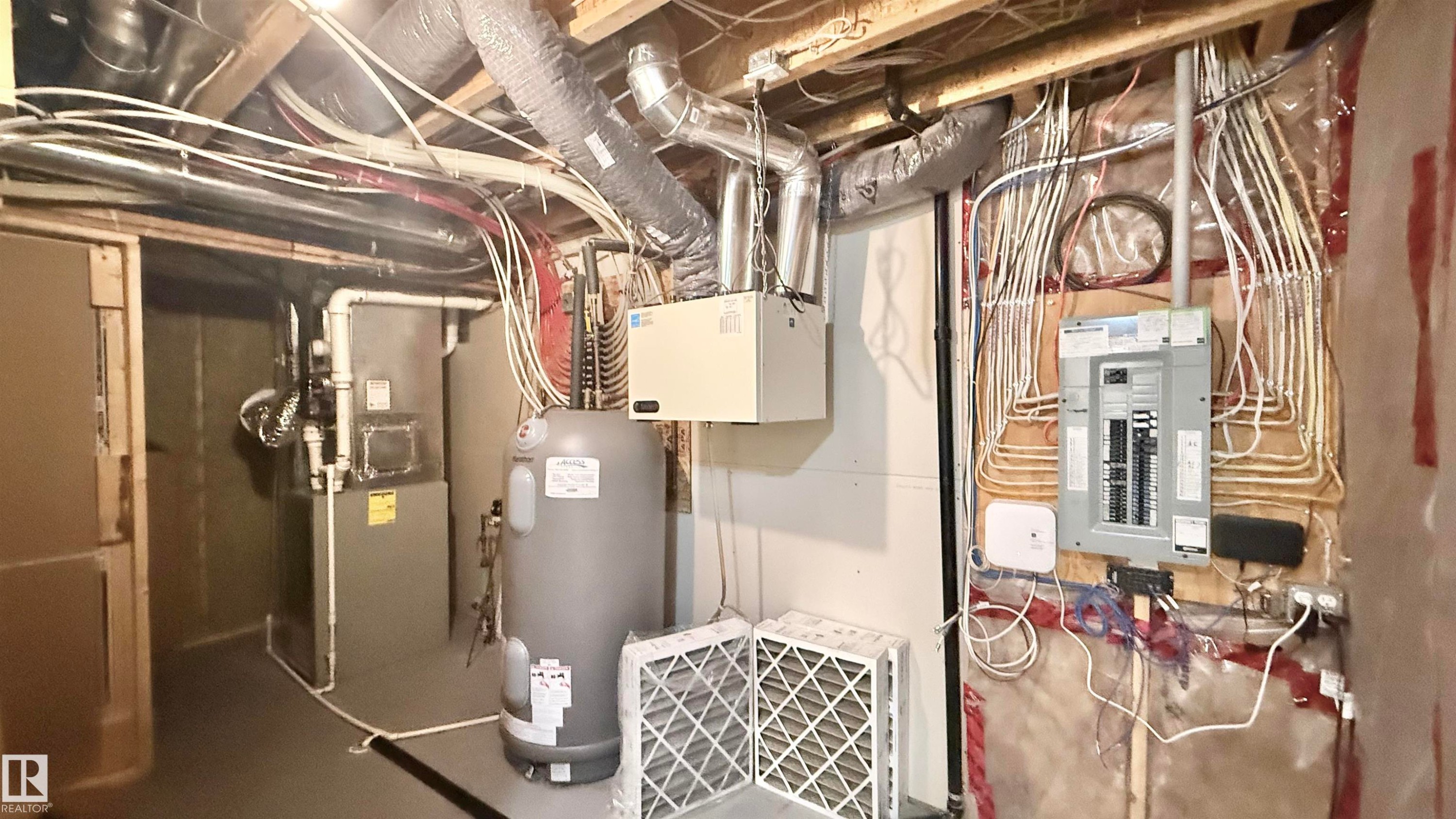 Utility room featuring a water heater, furnace, and electrical panel - 3962 Claxton Loop, Edmonton, AB - Indoor Photo Showing Basement